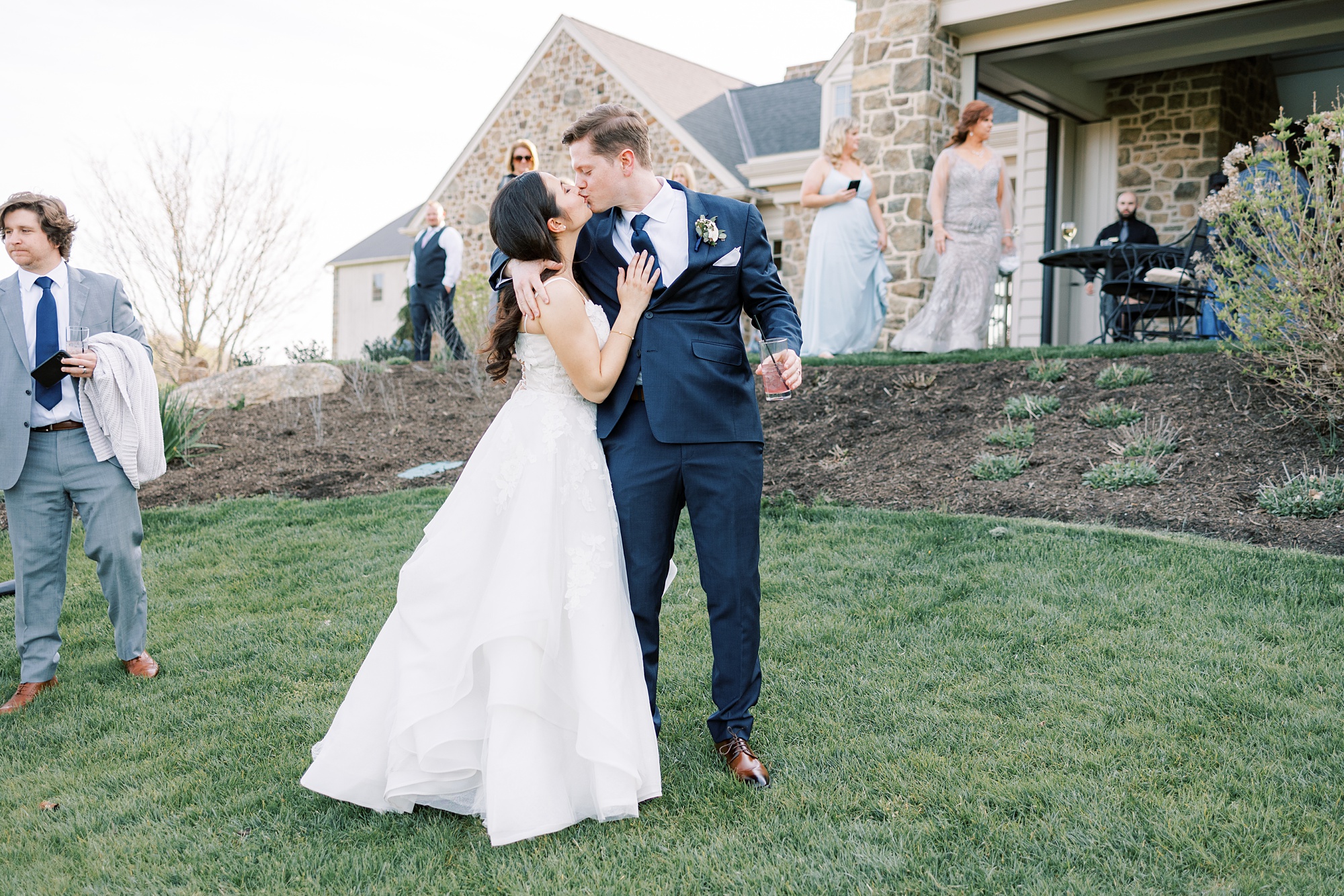 bride and groom kiss on hill at French Creek Golf Club 