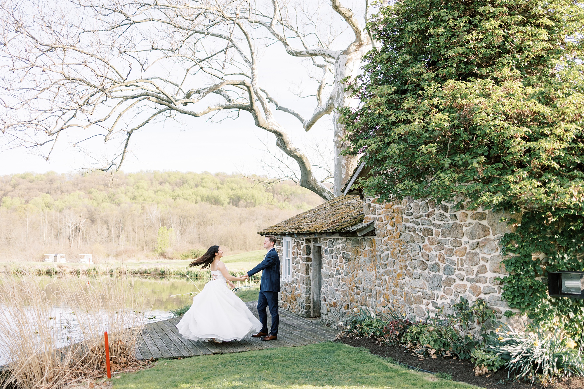 groom twirls bride during stone house at French Creek Golf Club 