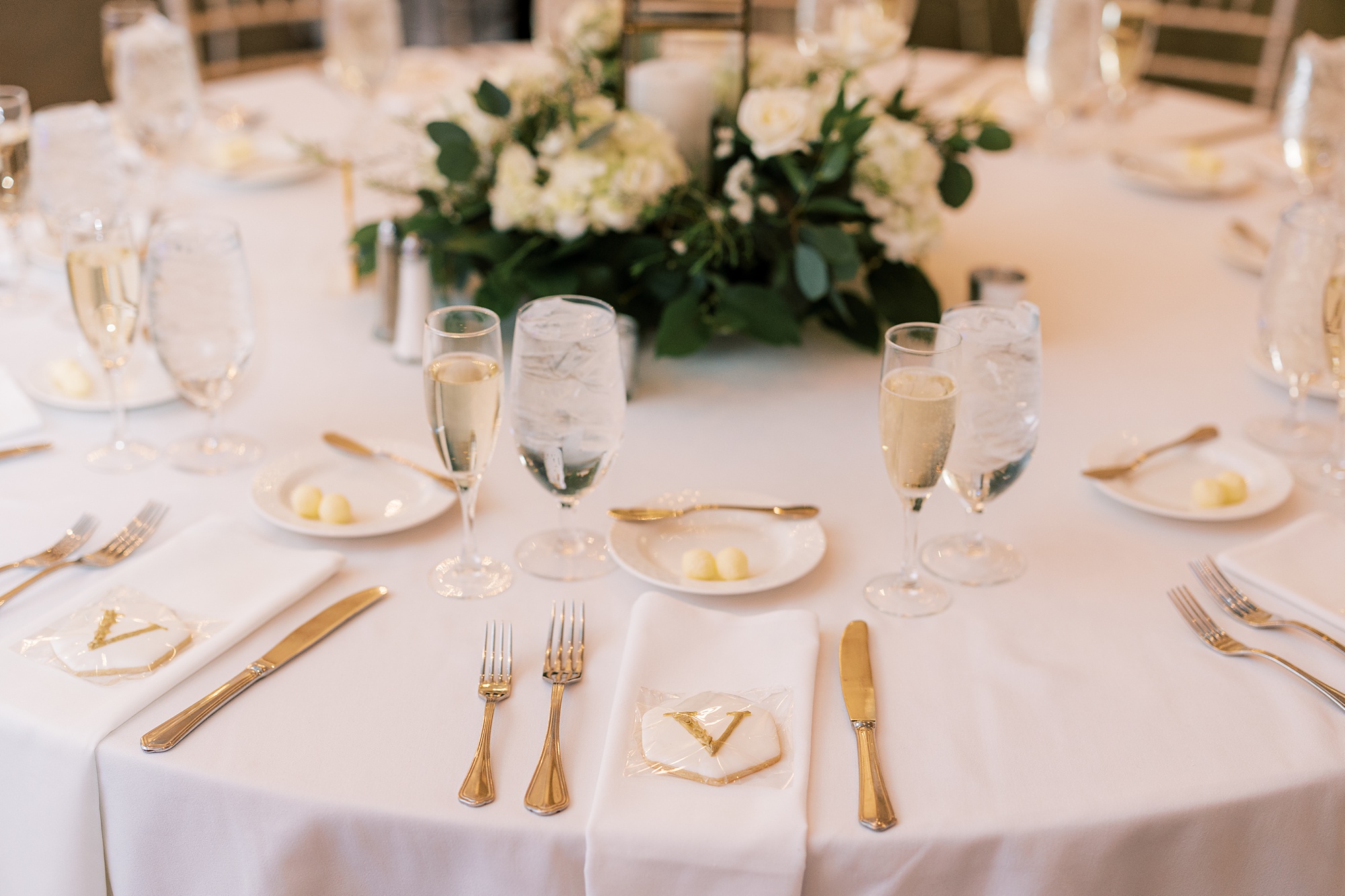 ivory and gold place settings for reception at French Creek Golf Club 