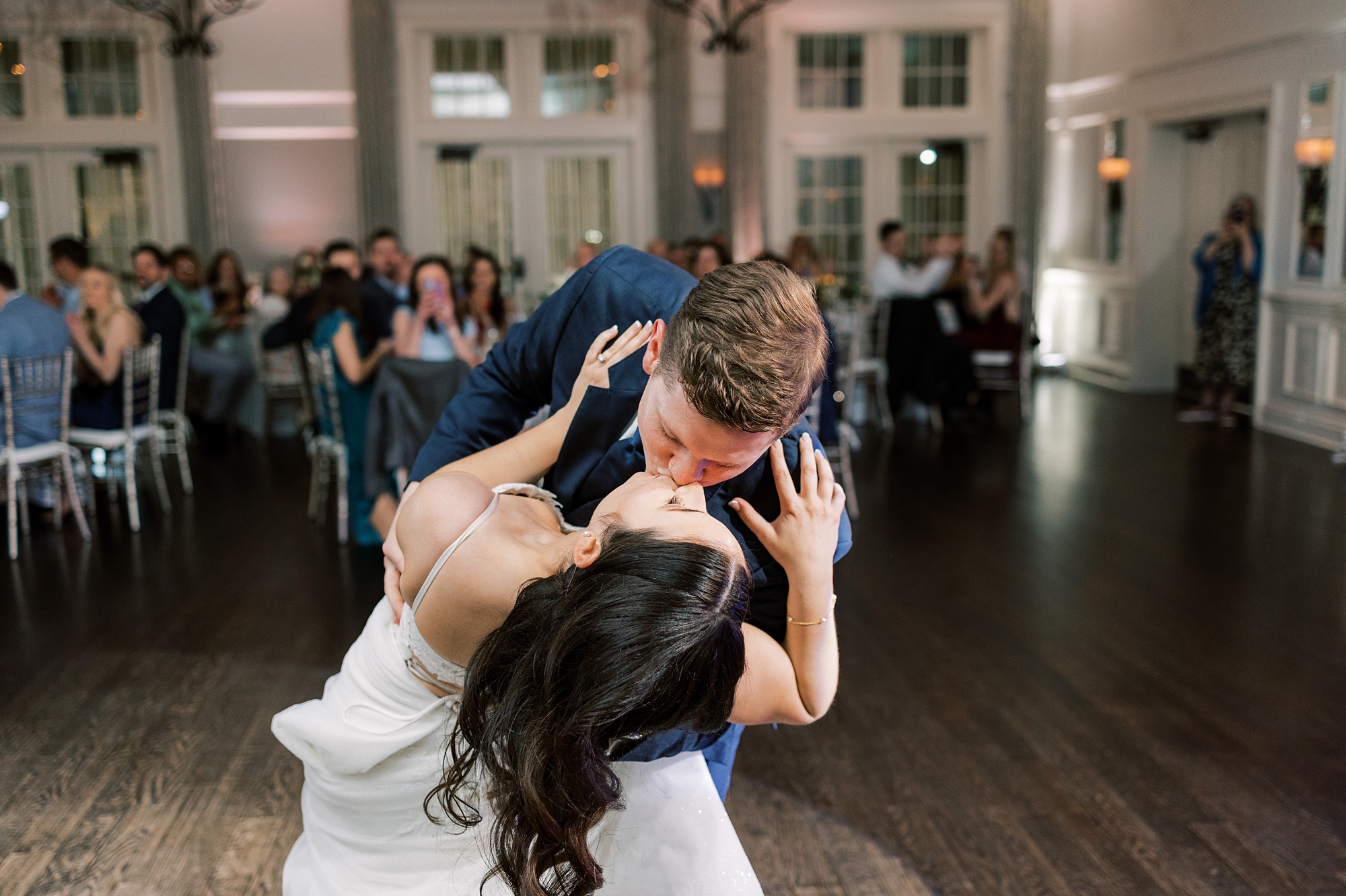 groom dips bride during first dance 
