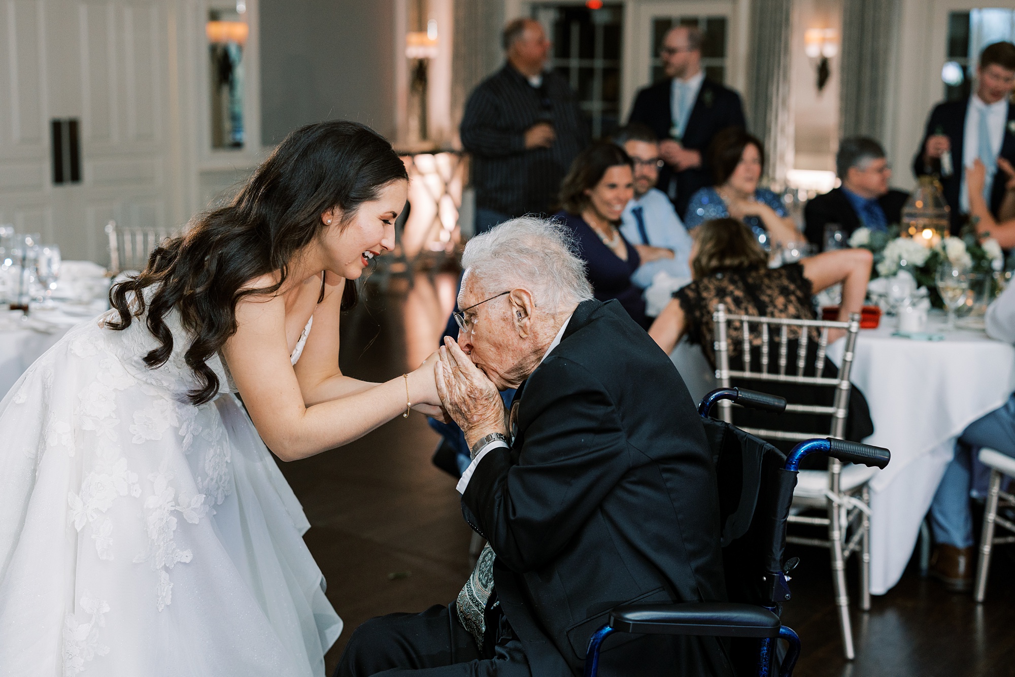 grandfather kisses bride's hand during dance at Chester County PA wedding reception