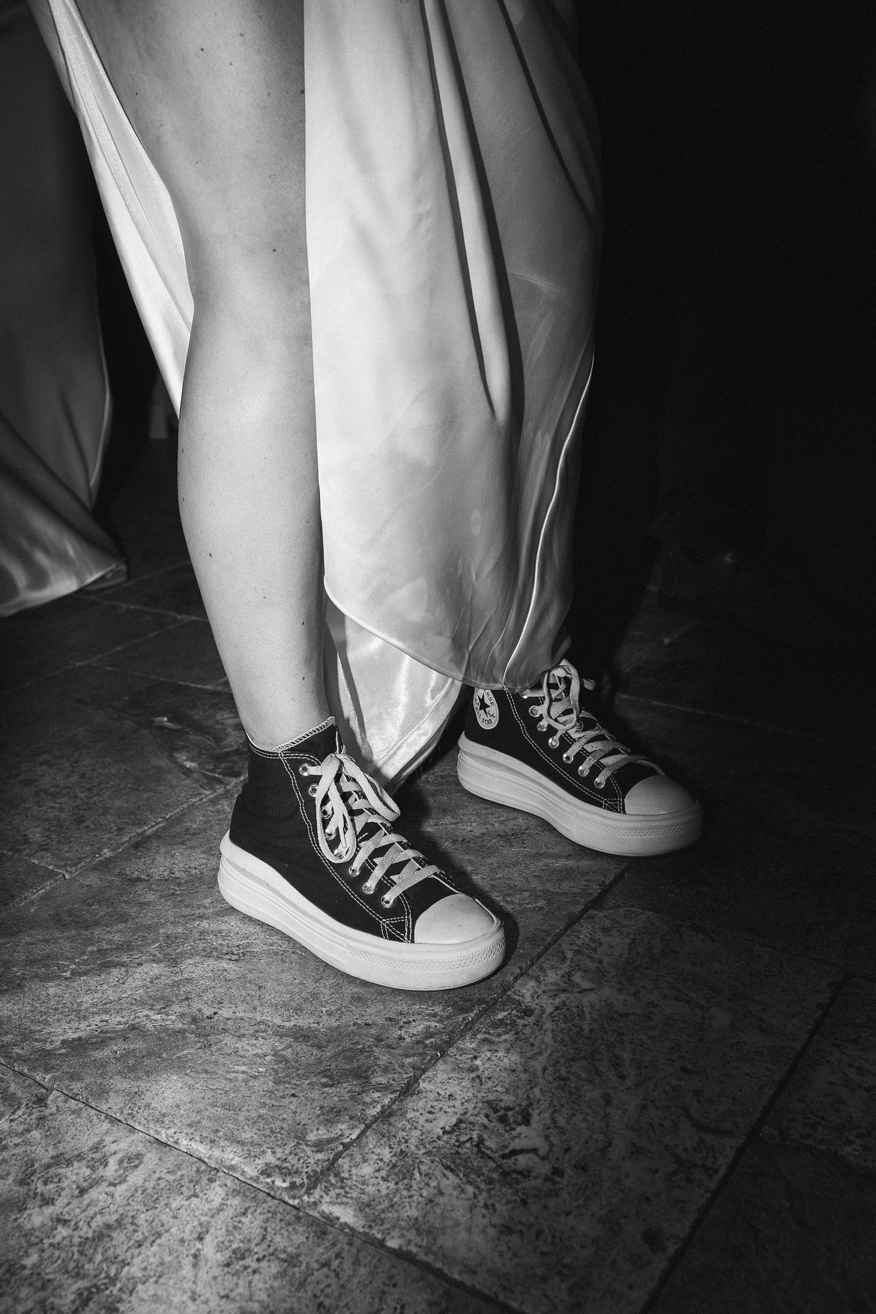 bride shows off black converse shoes 