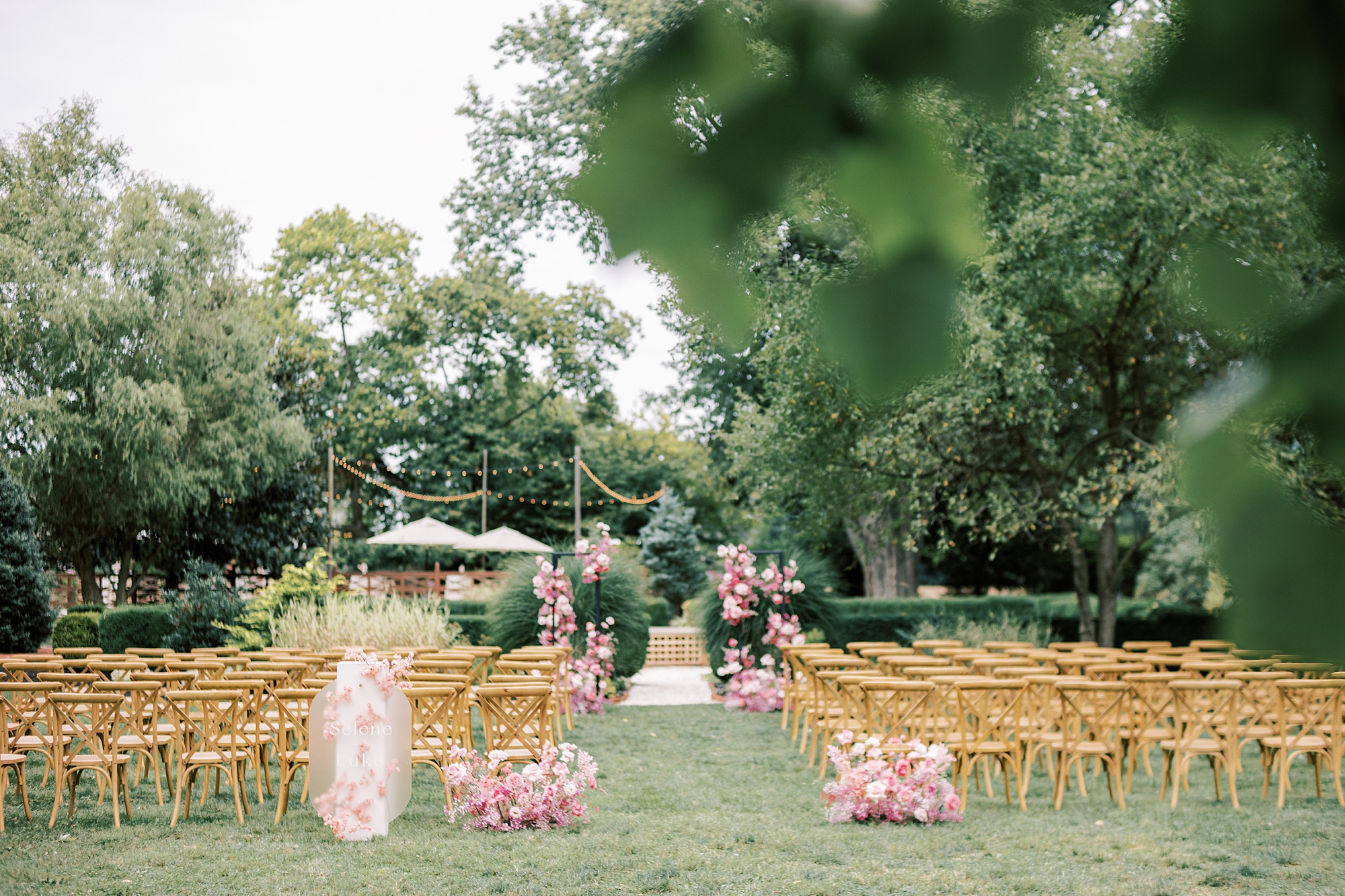 ceremony site on lawn at The Cypress House with monochromatic pink flowers