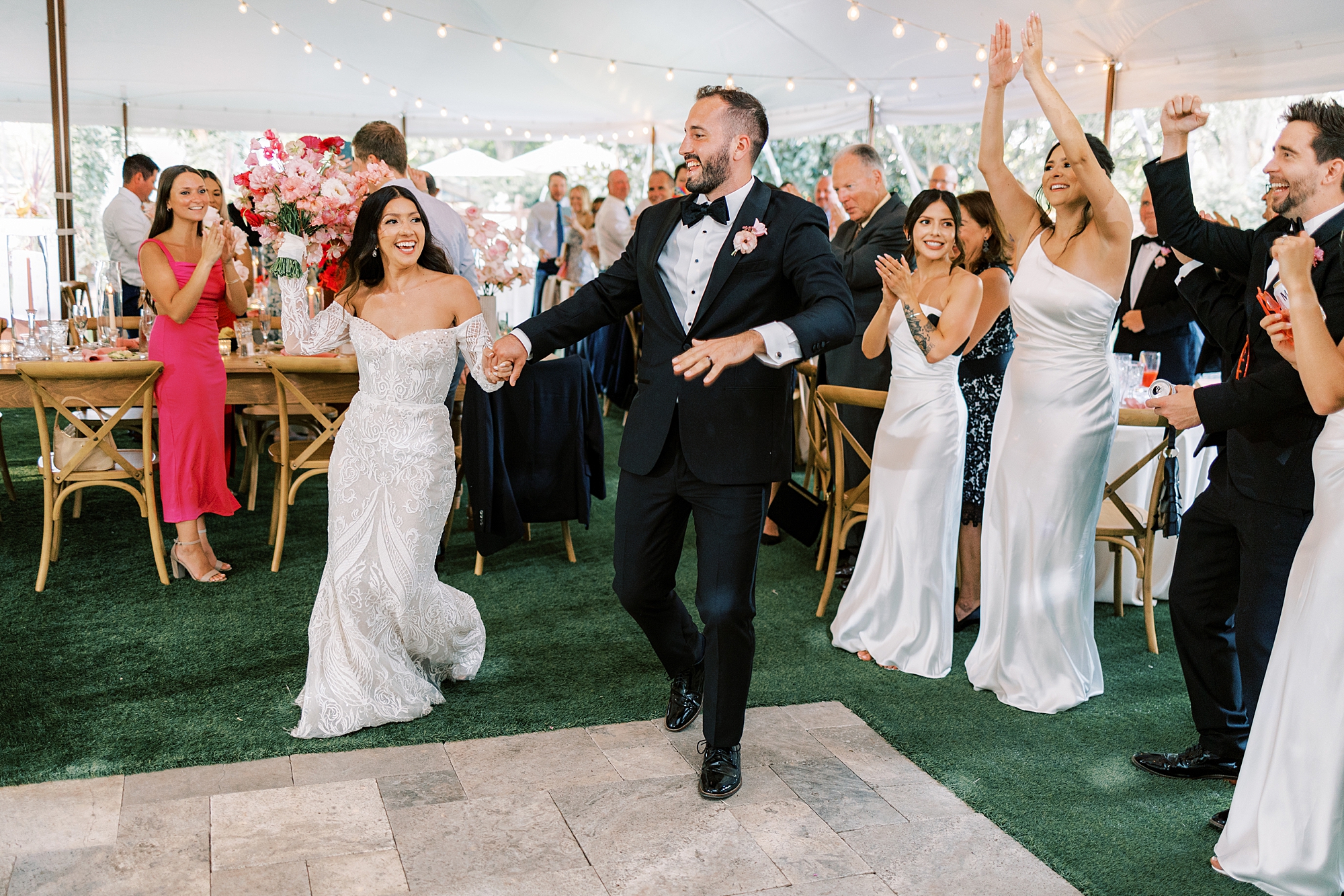 newlyweds walk onto dance floor under tent at The Cypress House