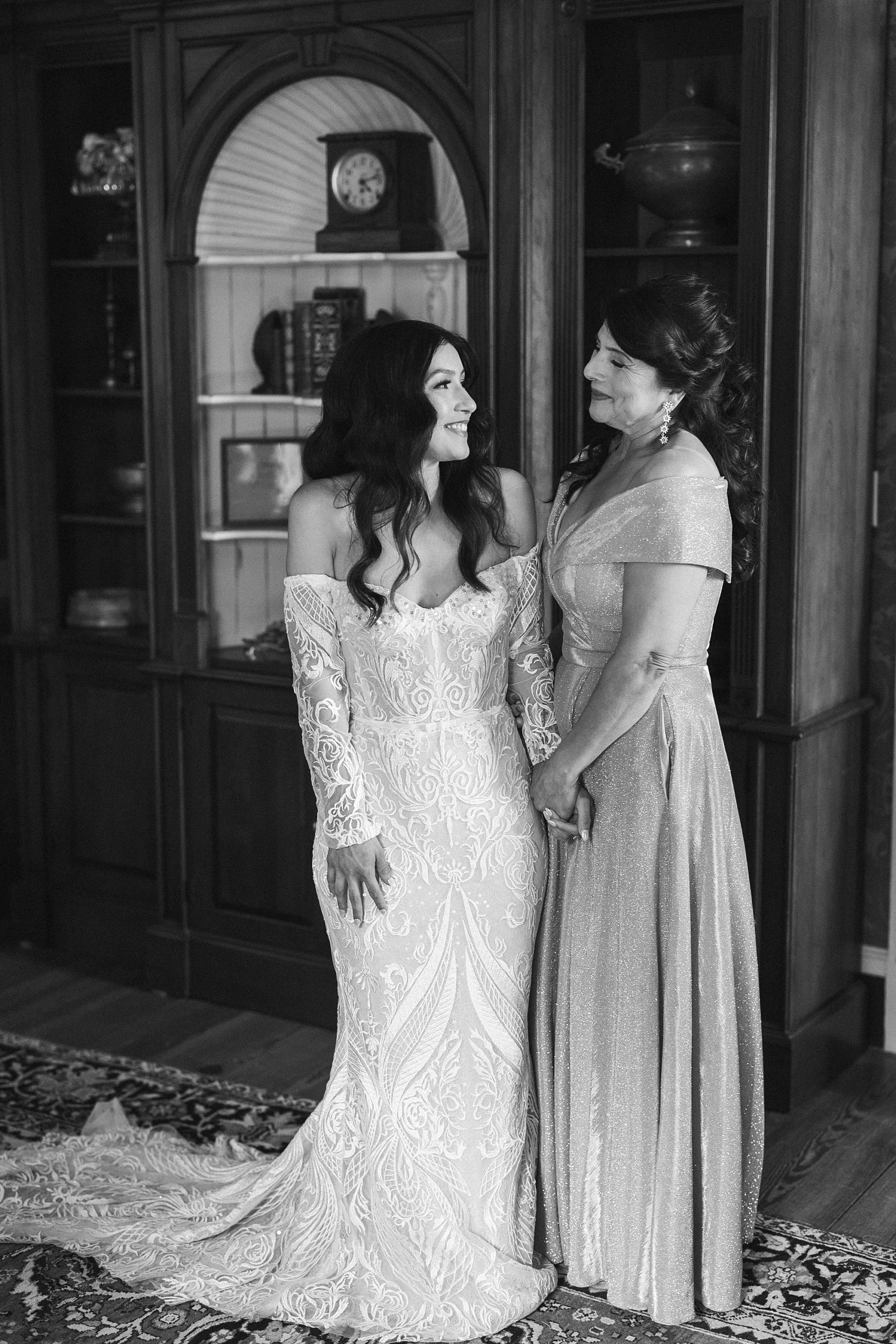 bride smiles at mother during prep at The Cypress House