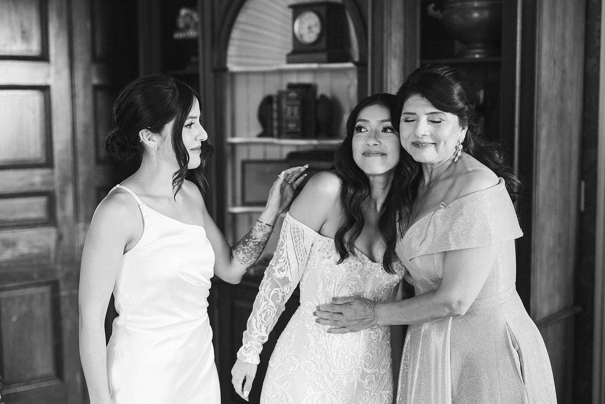 bride cries hugging mom and sister during prep at The Cypress House