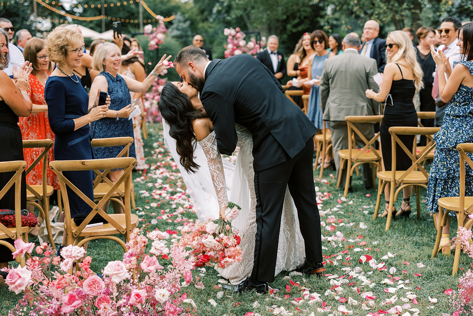 groom dips bride in aisle at The Cypress House