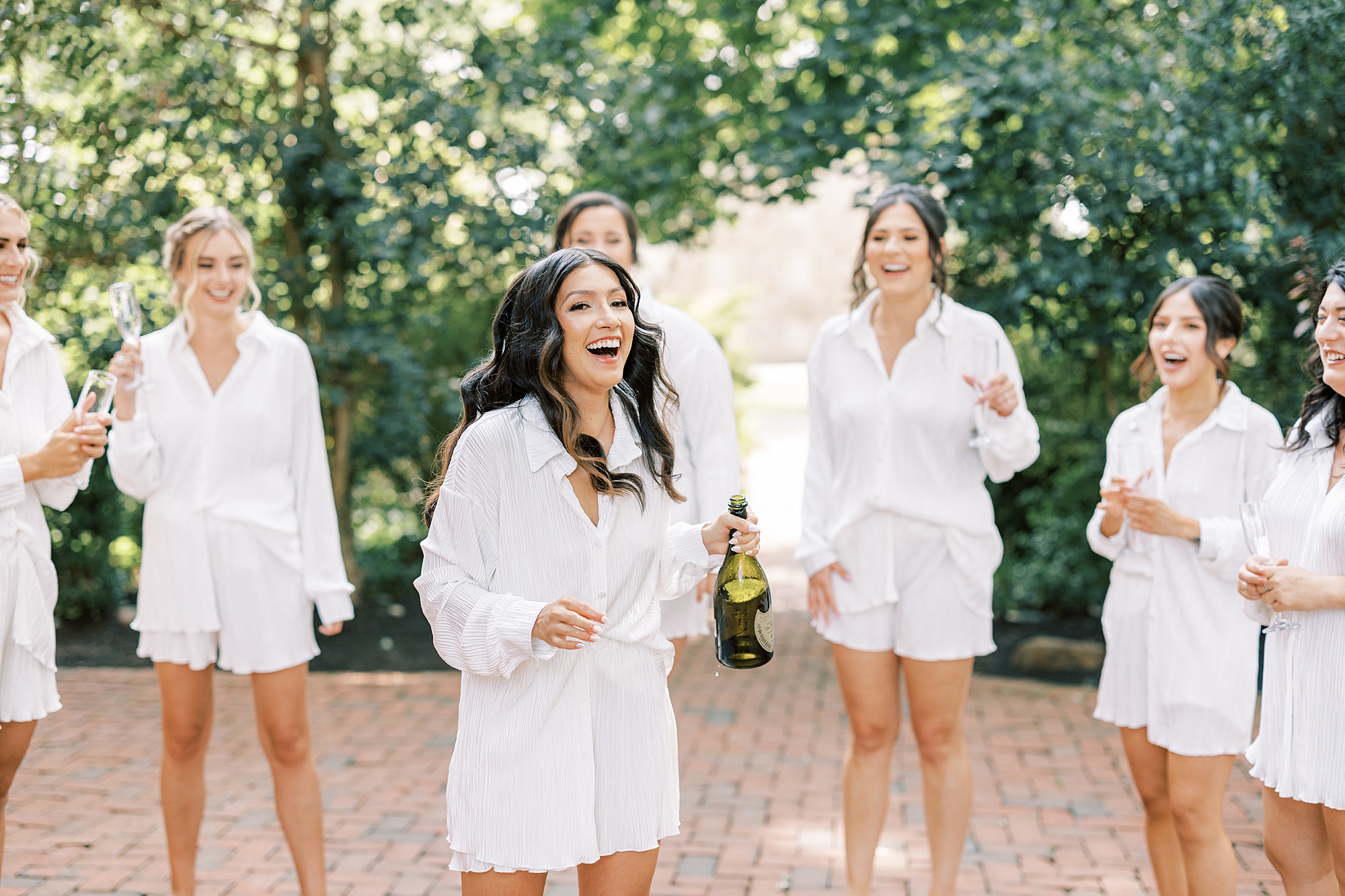 bride laughs after popping Champagne at The Cypress House