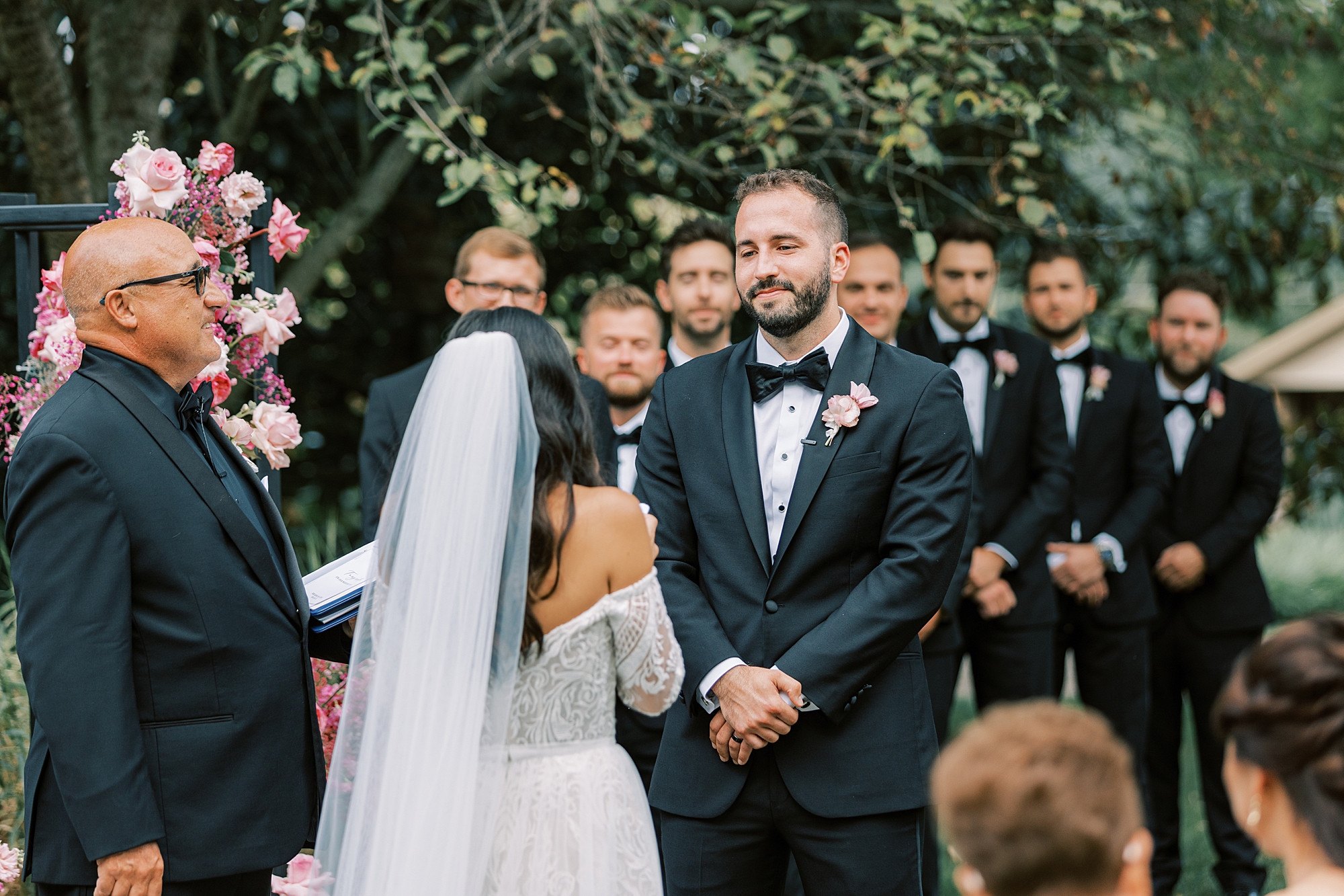 groom smiles at bride during ceremony at The Cypress House
