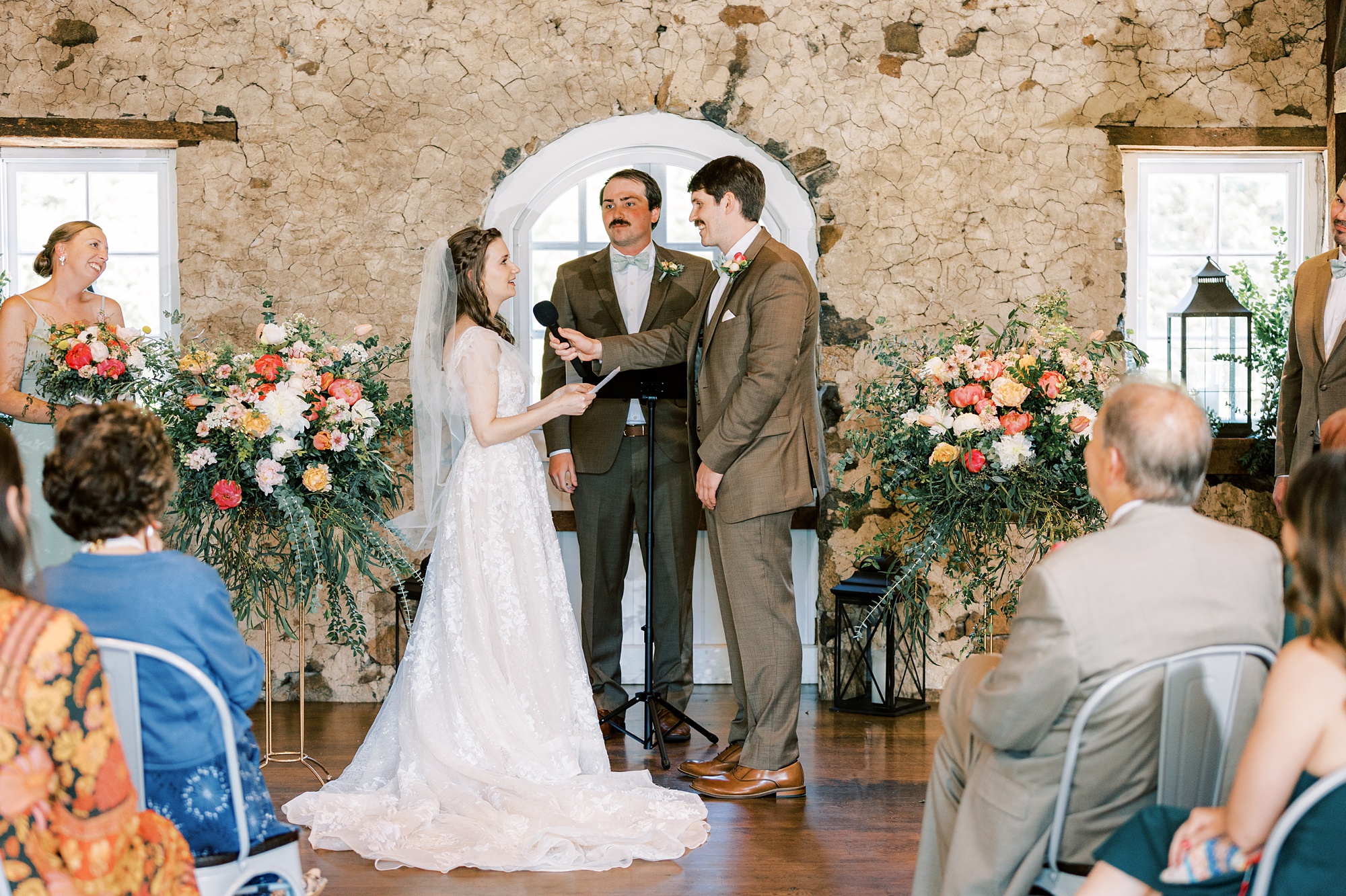wedding ceremony inside the stone barn at Tyler Arboretum