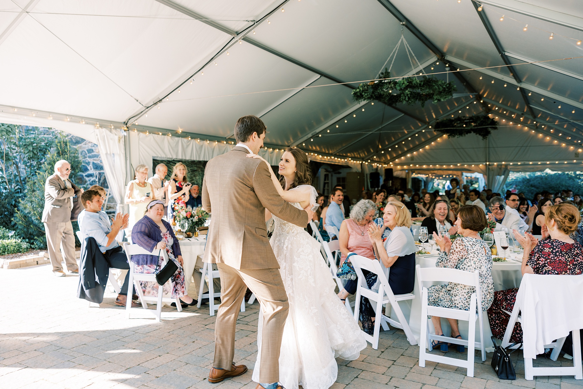 bride and groom have first dance under tent during wedding reception in Media PA