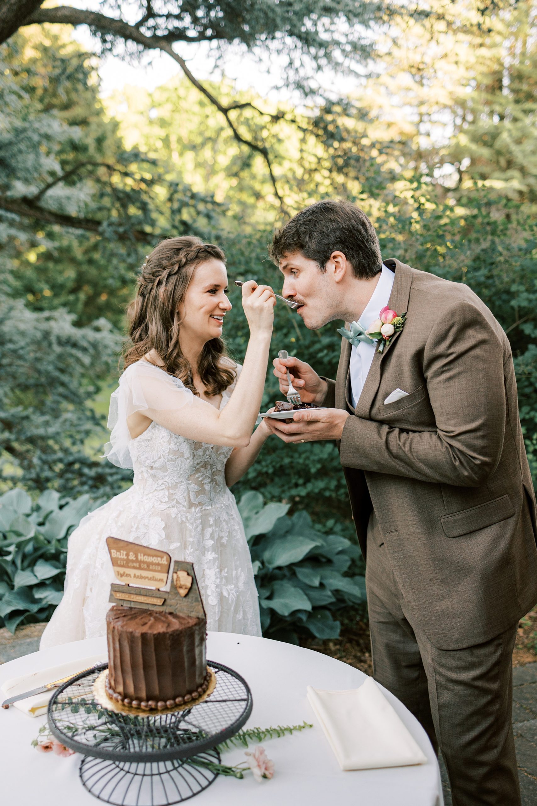 bride feeds groom cake at wedding reception in Media PA