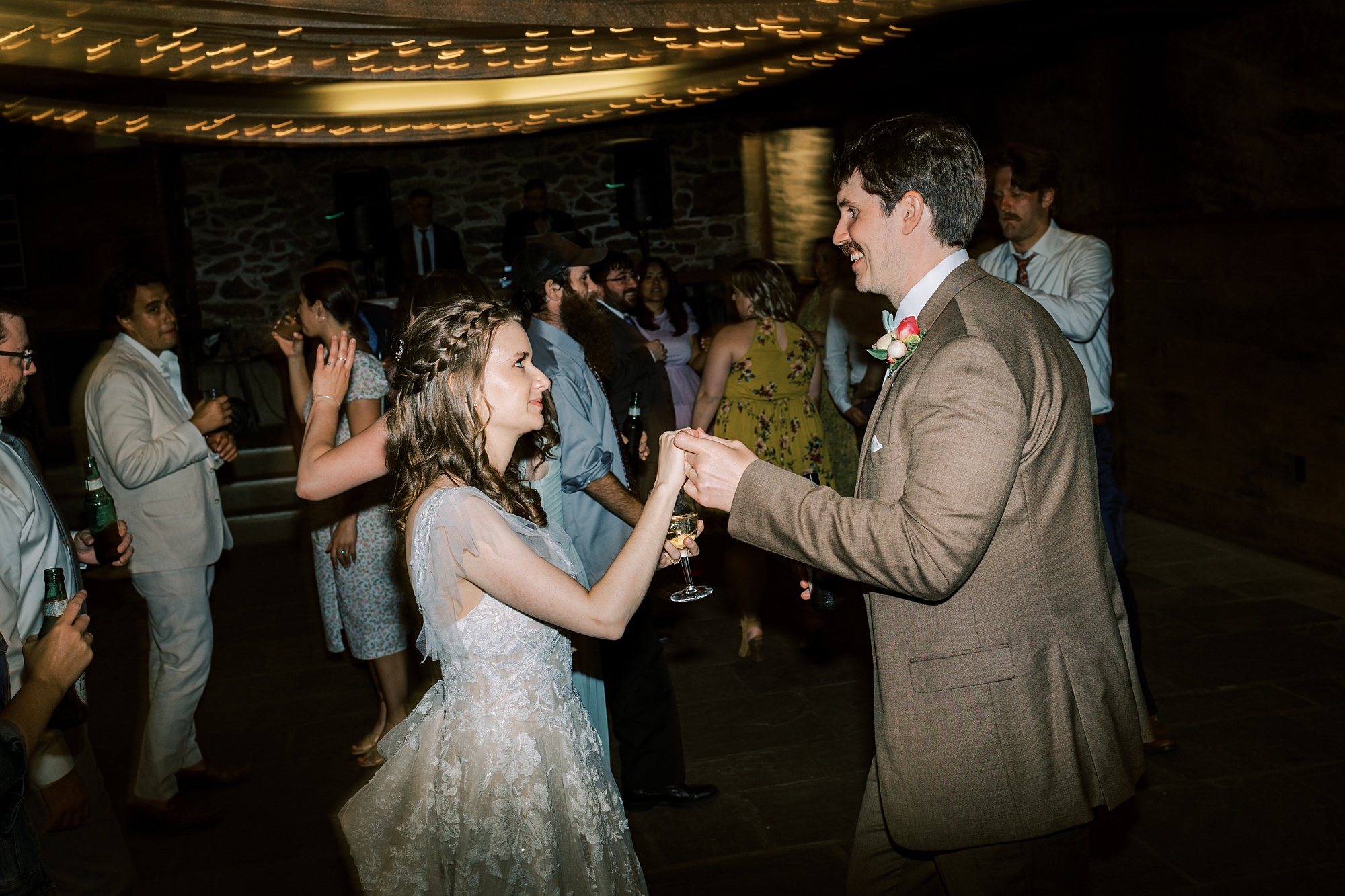 bride and groom dance with guests during wedding reception in Media PA
