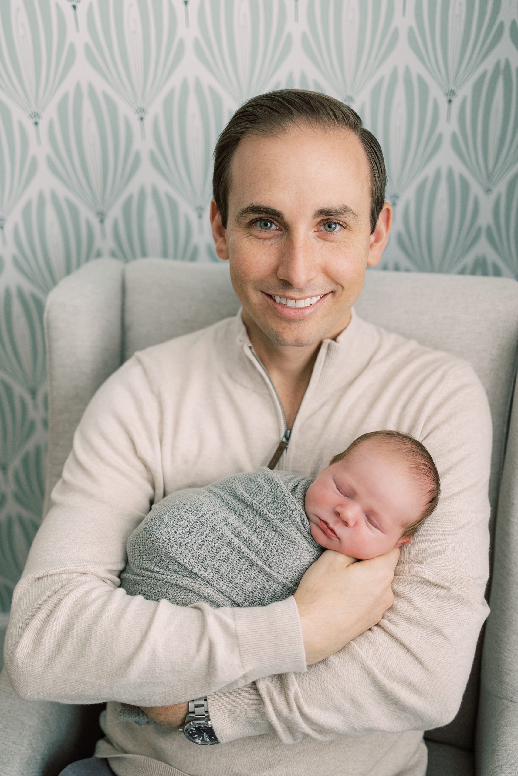 dad in cream top holds son during PA newborn session