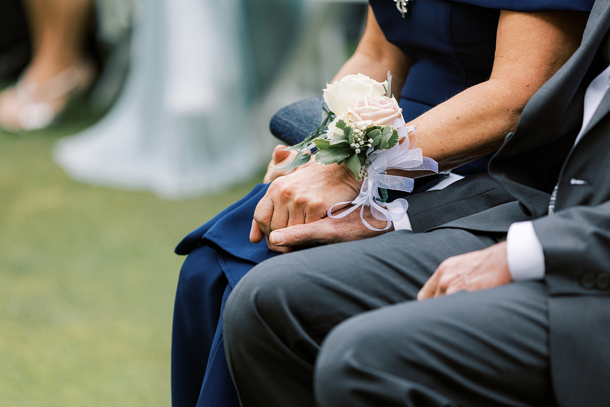parents hold hands during wedding ceremony at Huntingdon Valley Country Club