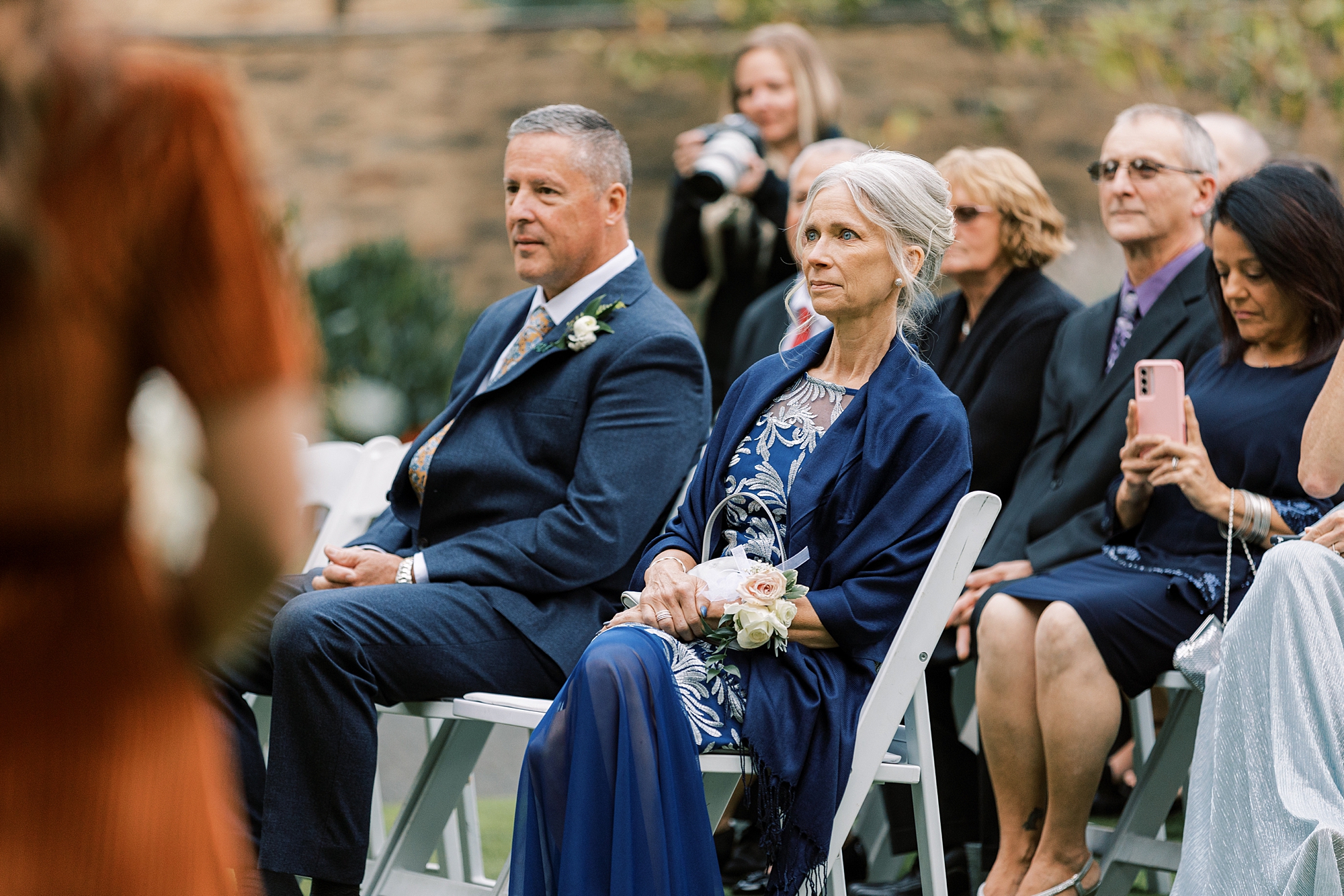 parents watch wedding ceremony on lawn