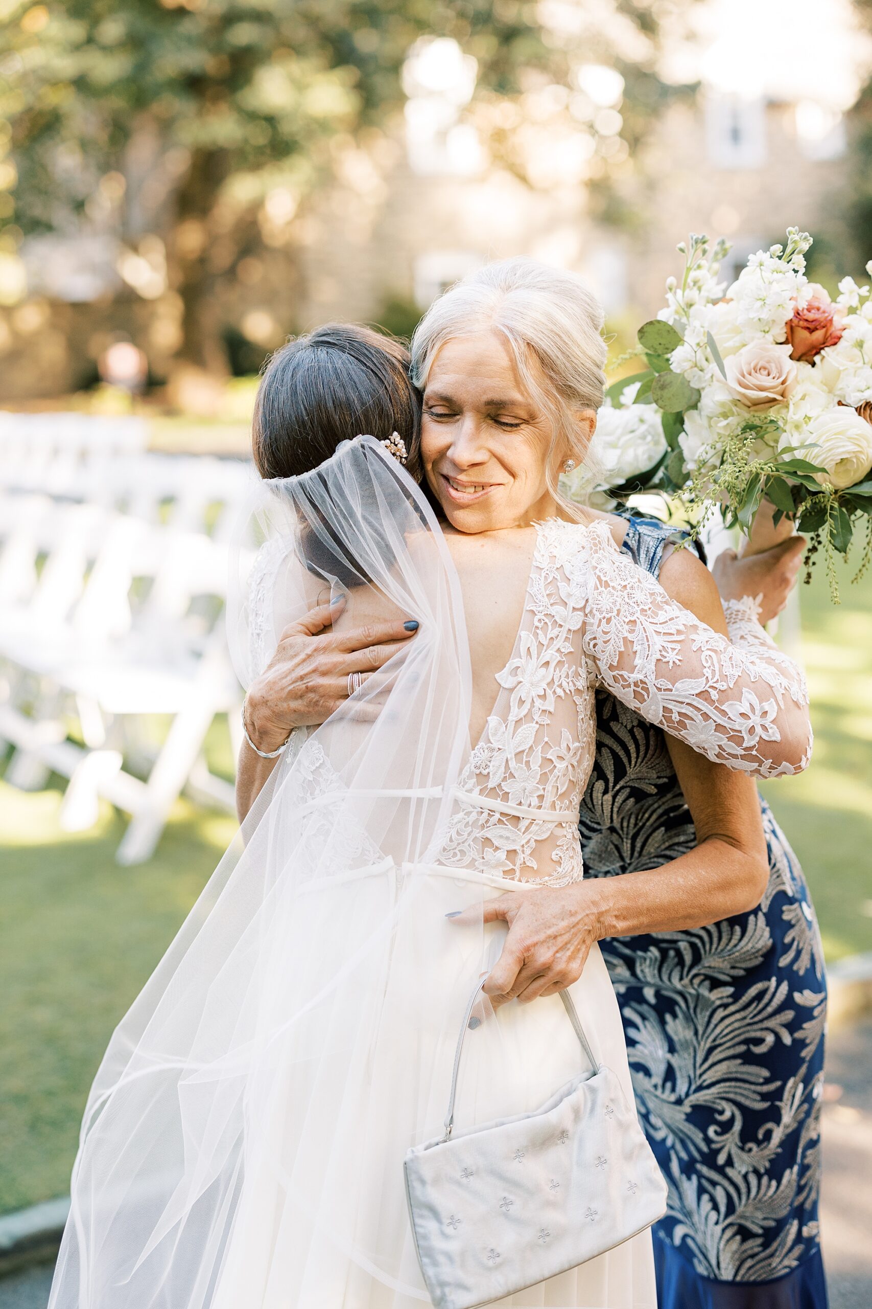 bride hugs mother-in-law during ceremony