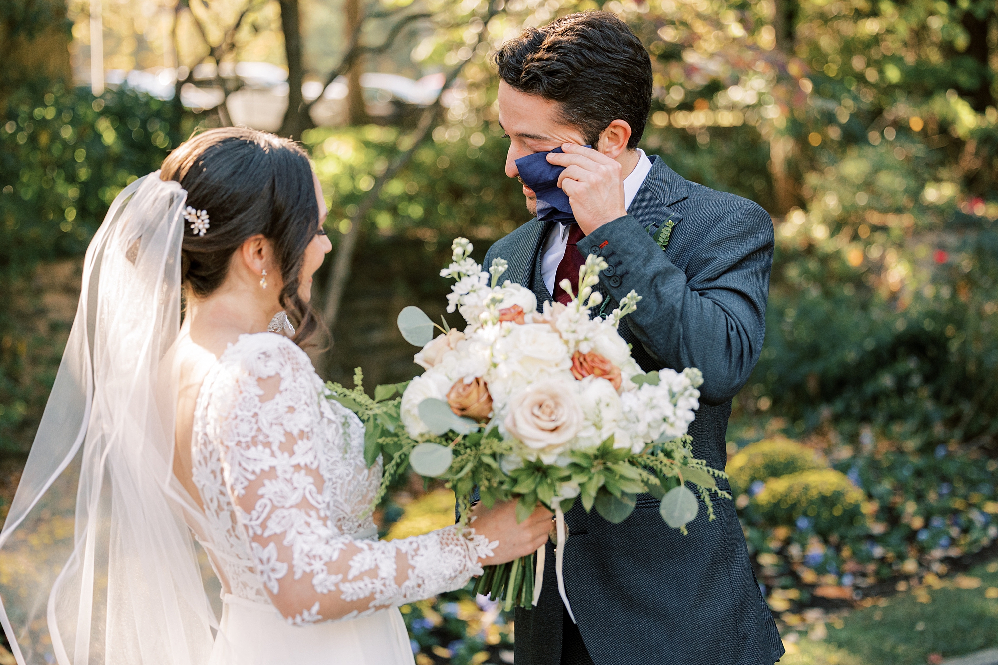 groom wipes away tears during first look
