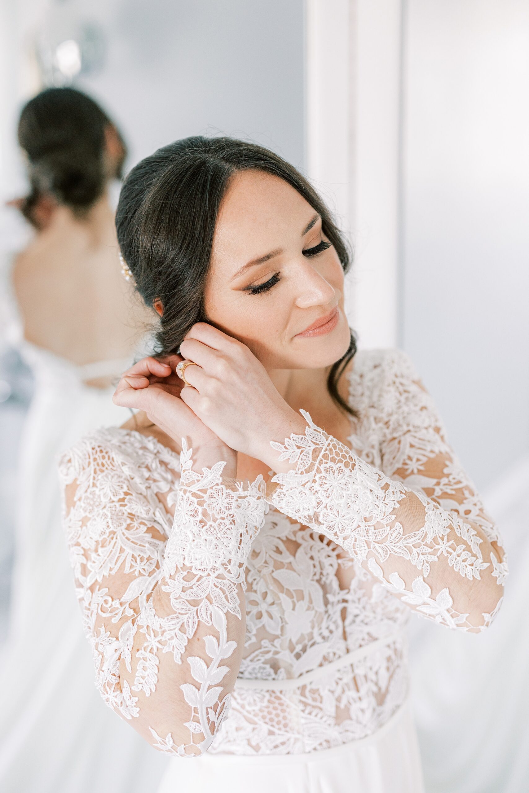 bride puts on earrings before fall Huntingdon Valley Country Club wedding