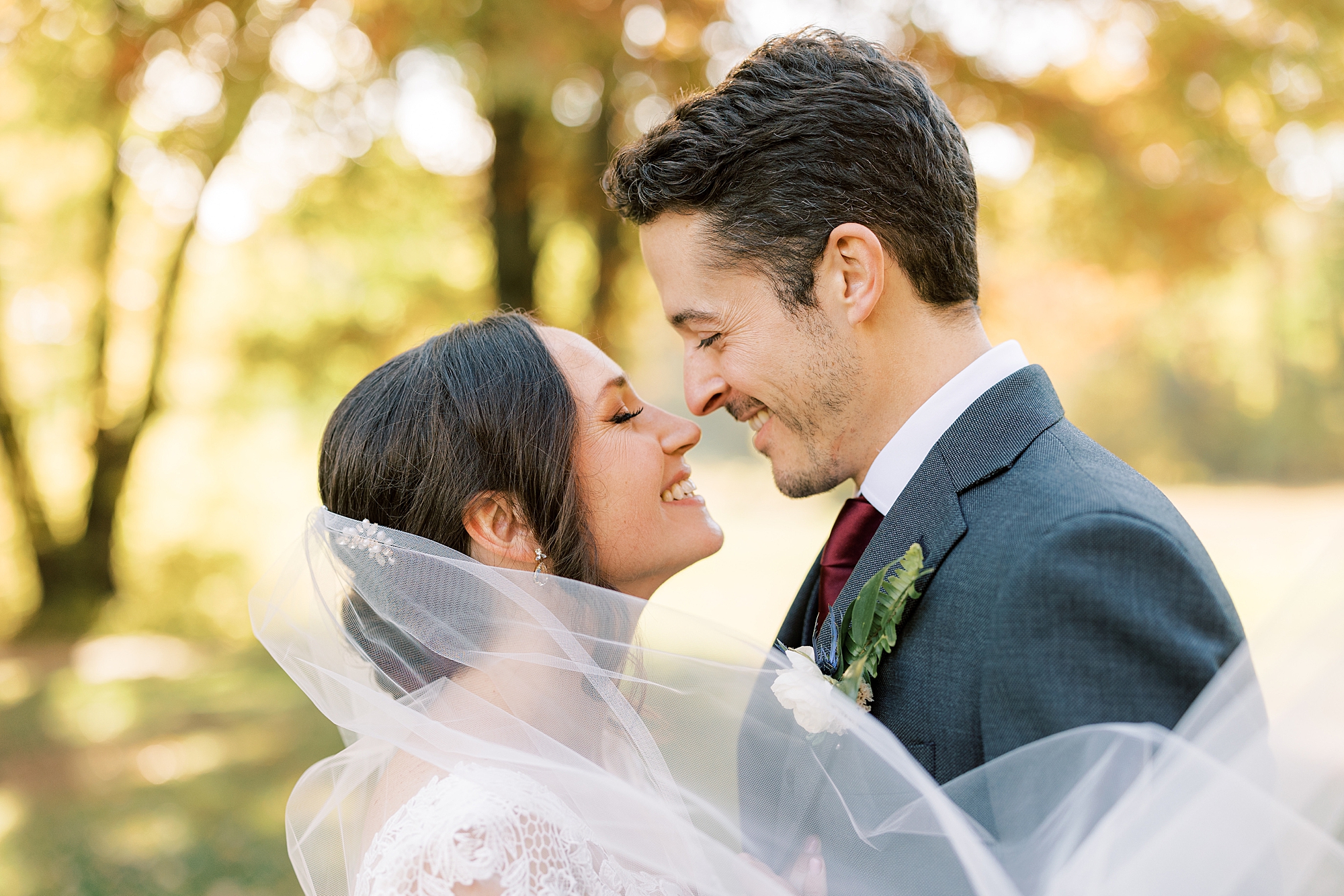 bride and from lean and nuzzle noses during fall wedding portraits