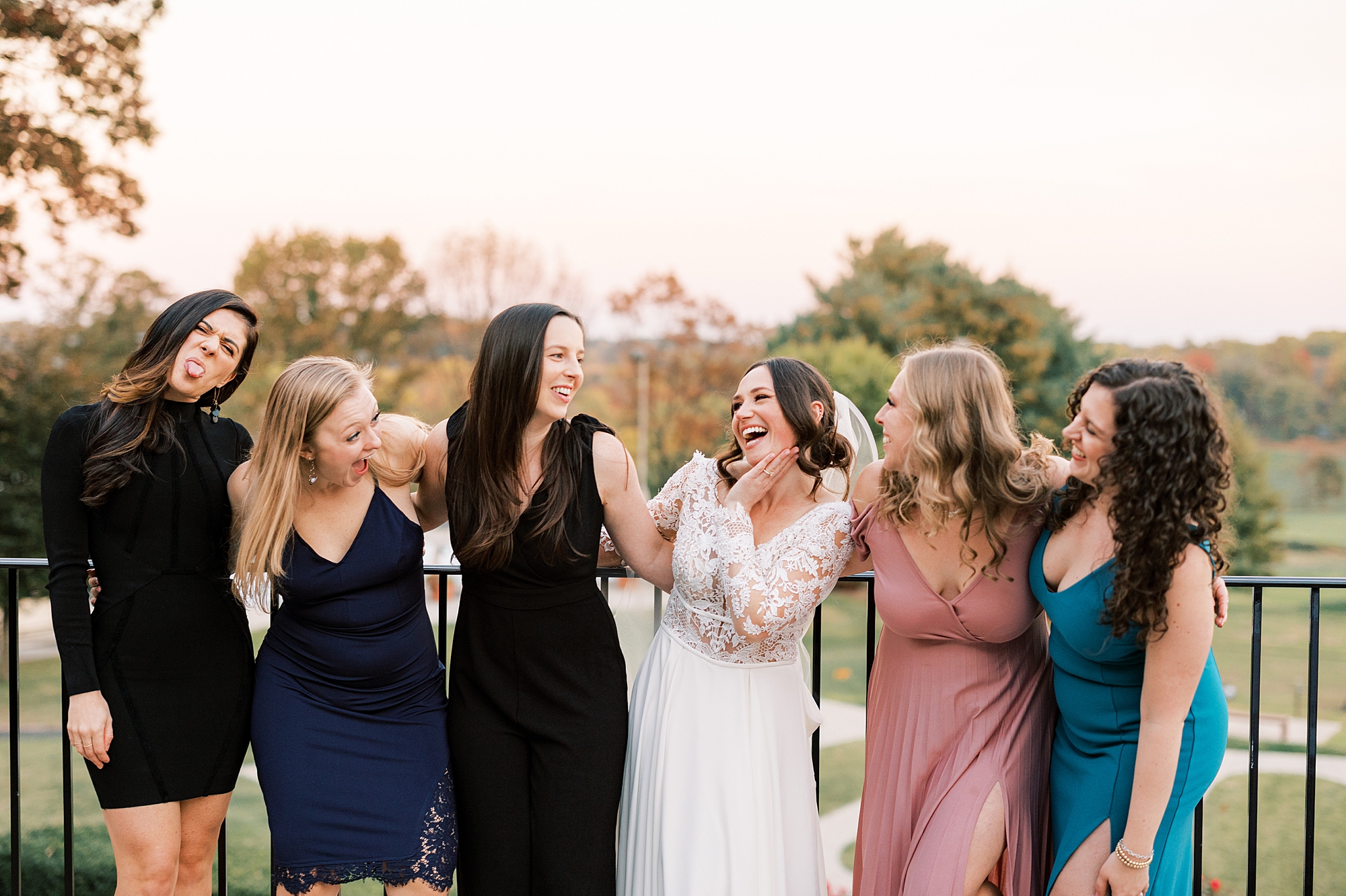 bride poses with five female friends on balcony at Huntingdon Valley Country Club