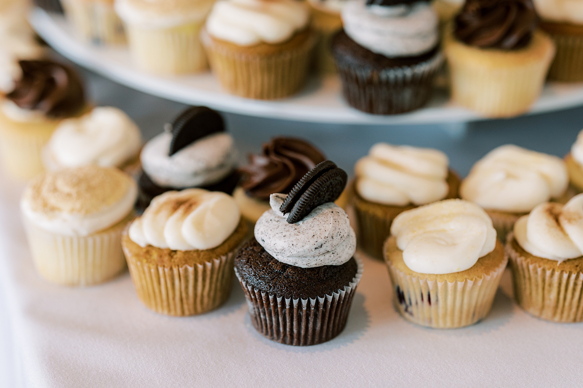 close up of various cupcakes on tier at Huntingdon Valley Country Club