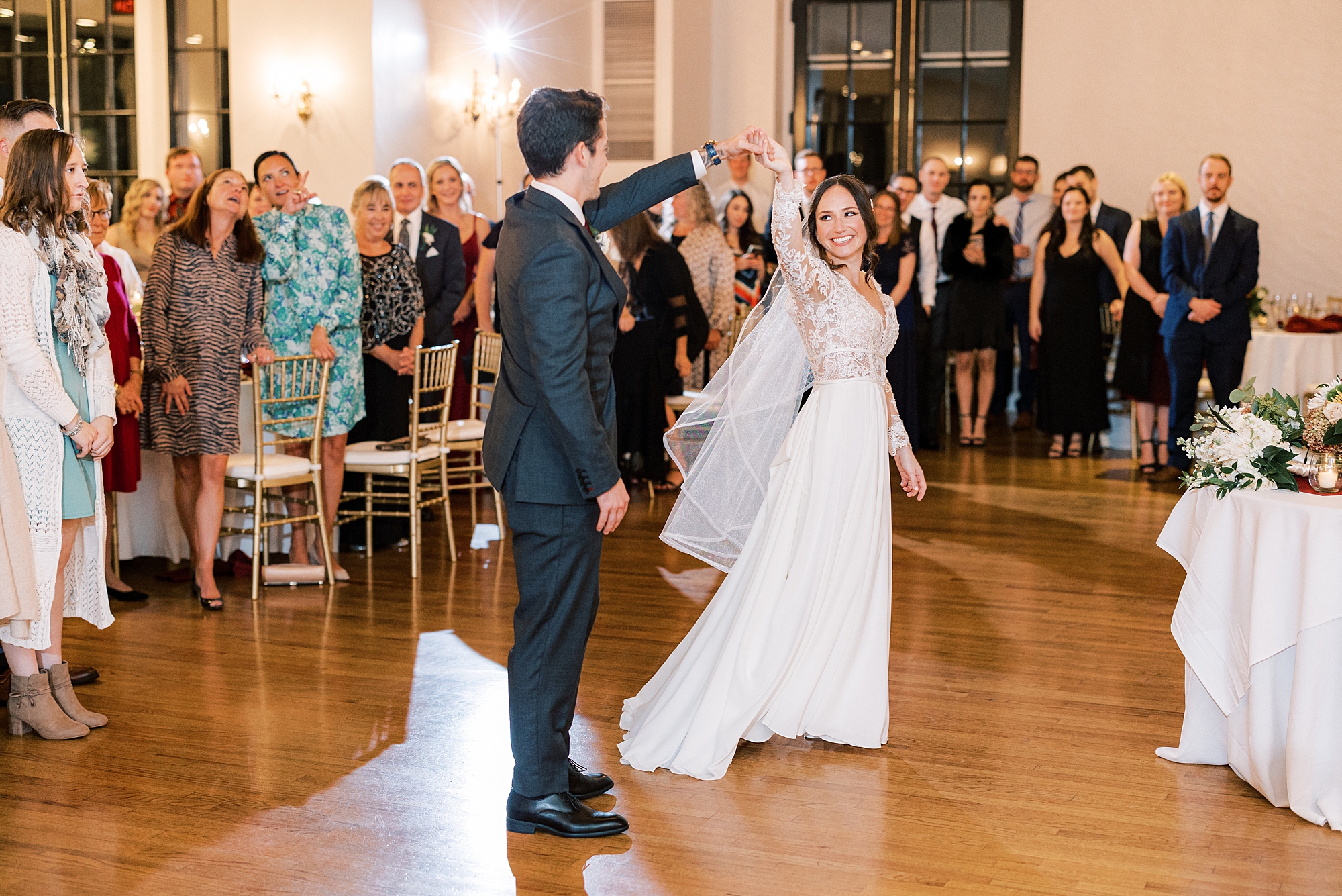 groom twirls bride during first dance during Huntingdon Valley PA wedding reception