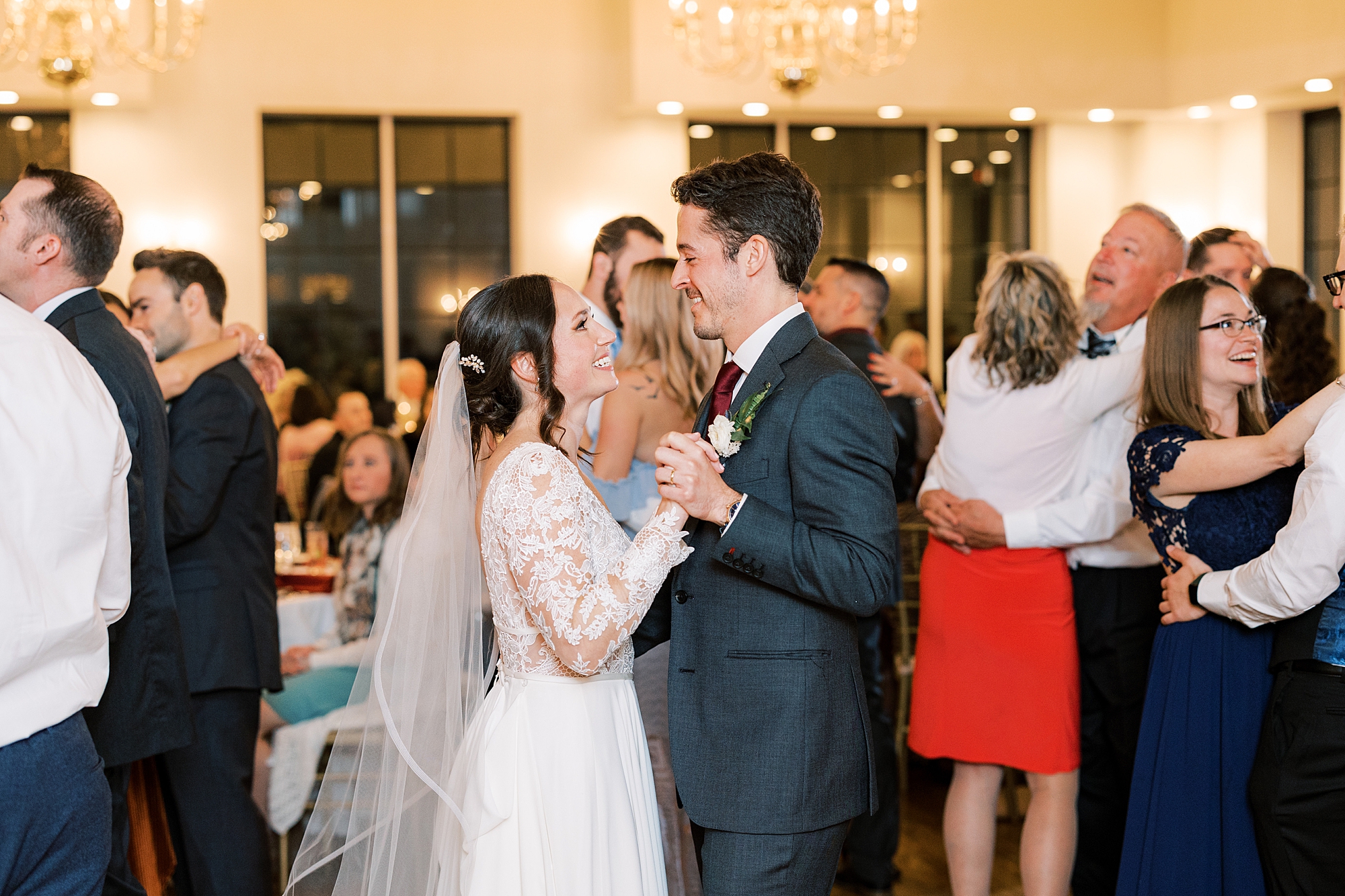 newlyweds dance with wedding guests around them at Huntingdon Valley Country Club