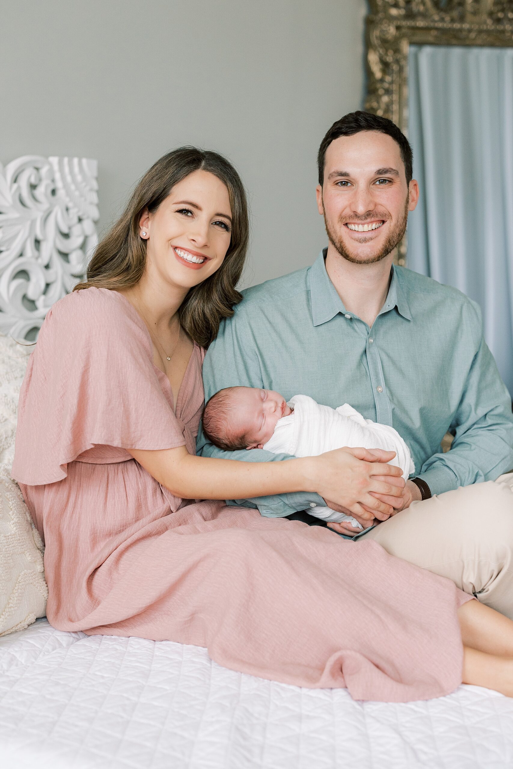 new parents hold baby girl during studio newborn session in Philadelphia PA