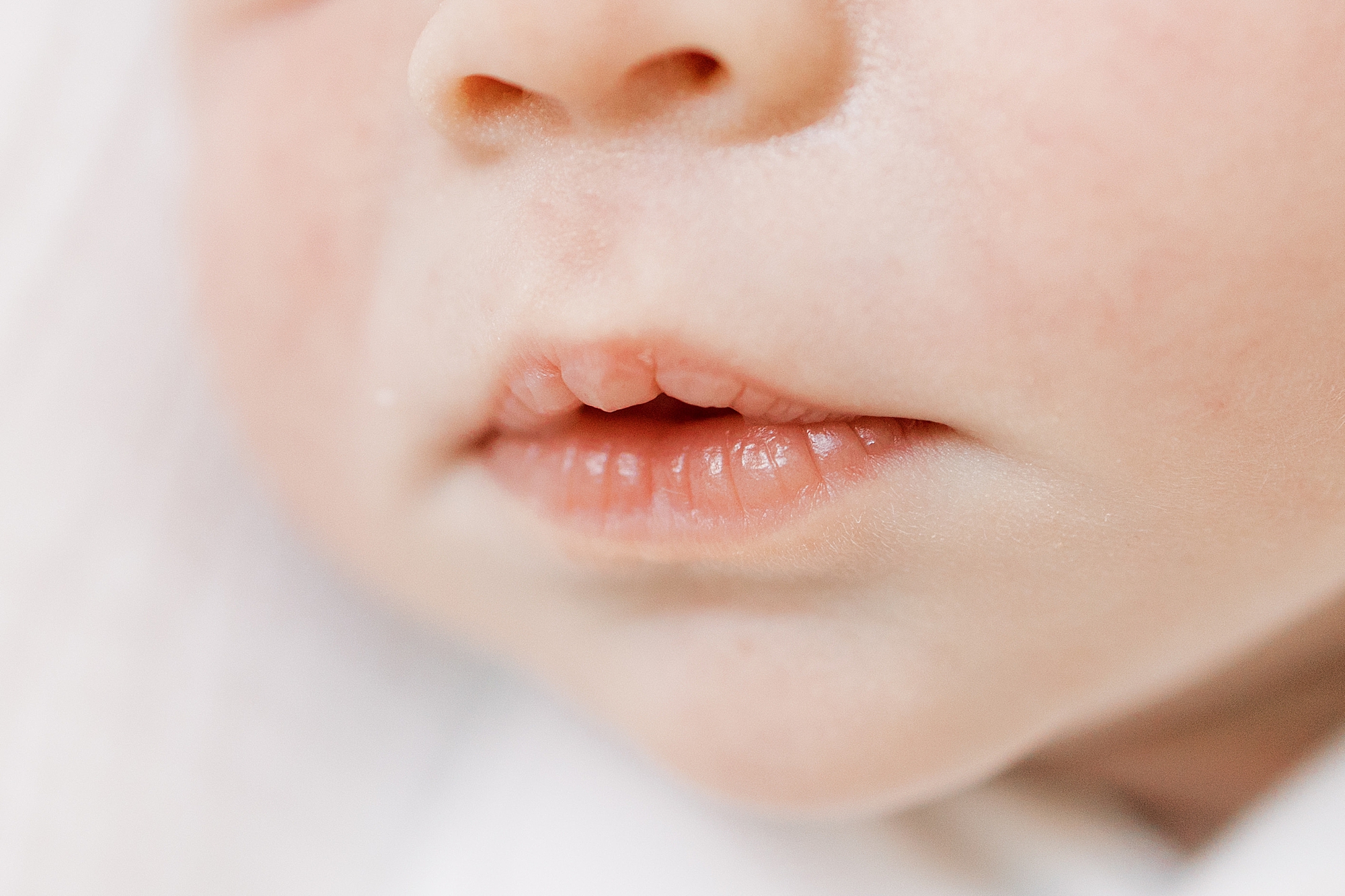 close up of baby's lips during newborn photos 
