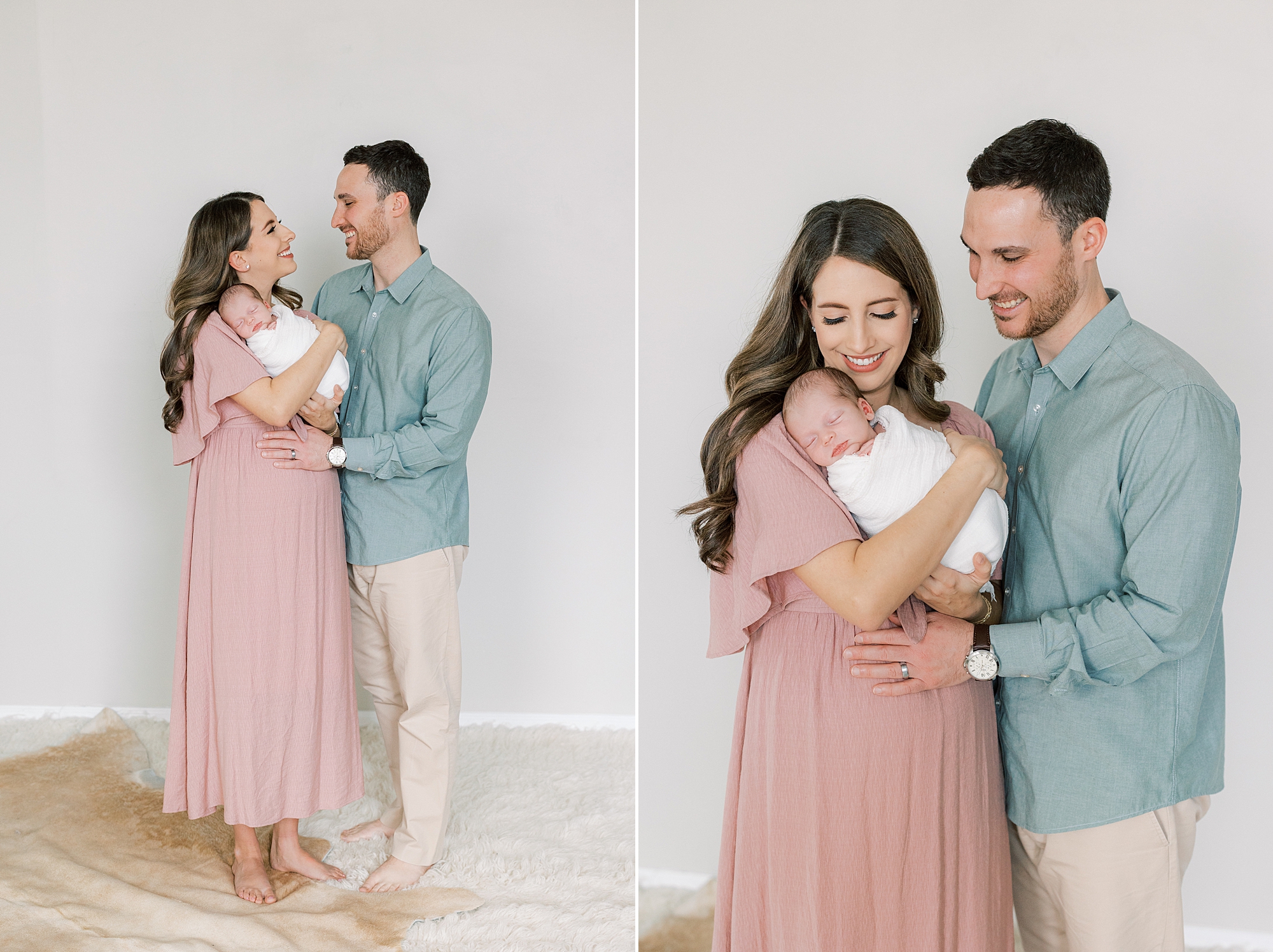 parents smile at baby girl during newborn photos in Philly PA