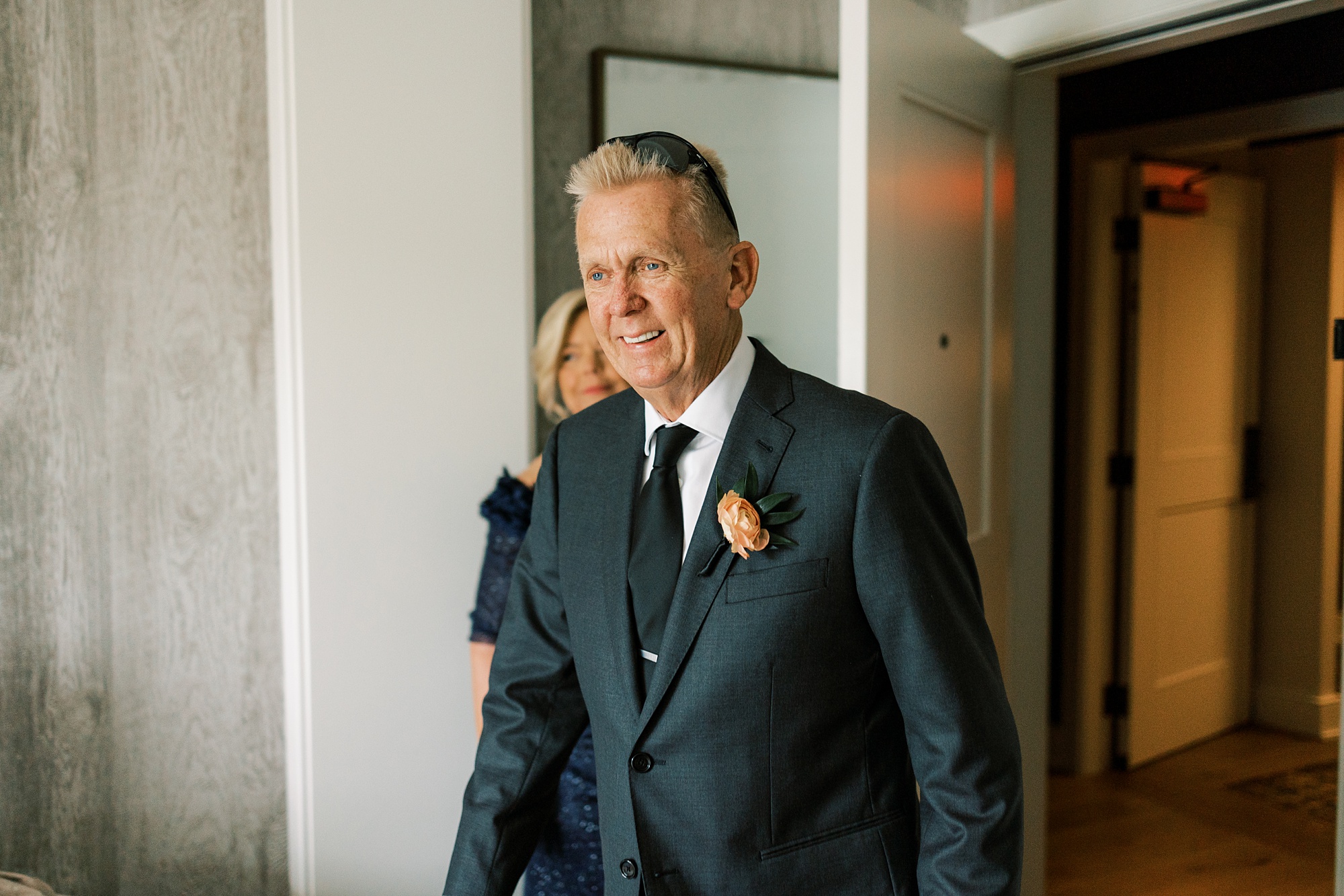 father walks into room for first look with bride at The River House at Odette's