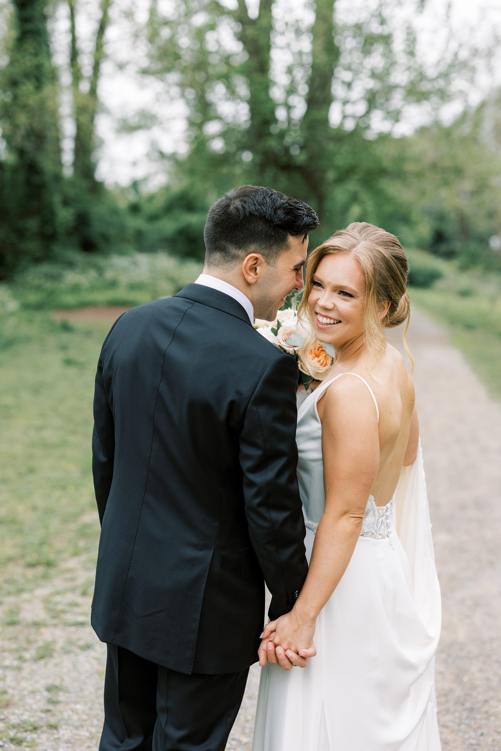 groom leans into bride's cheek during portraits in New Hope PA