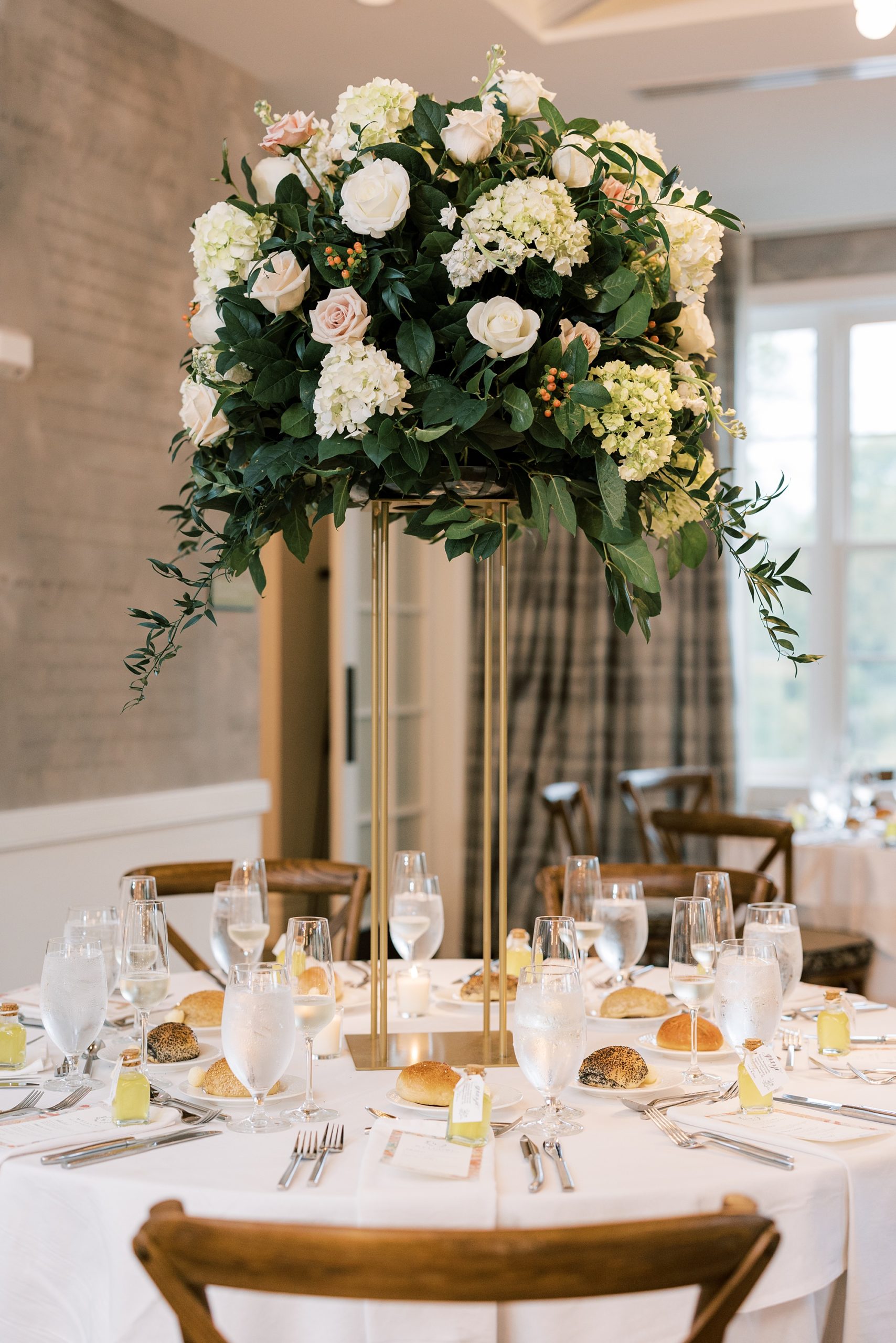 tall floral centerpiece for Italian inspired wedding reception at The River House at Odette's