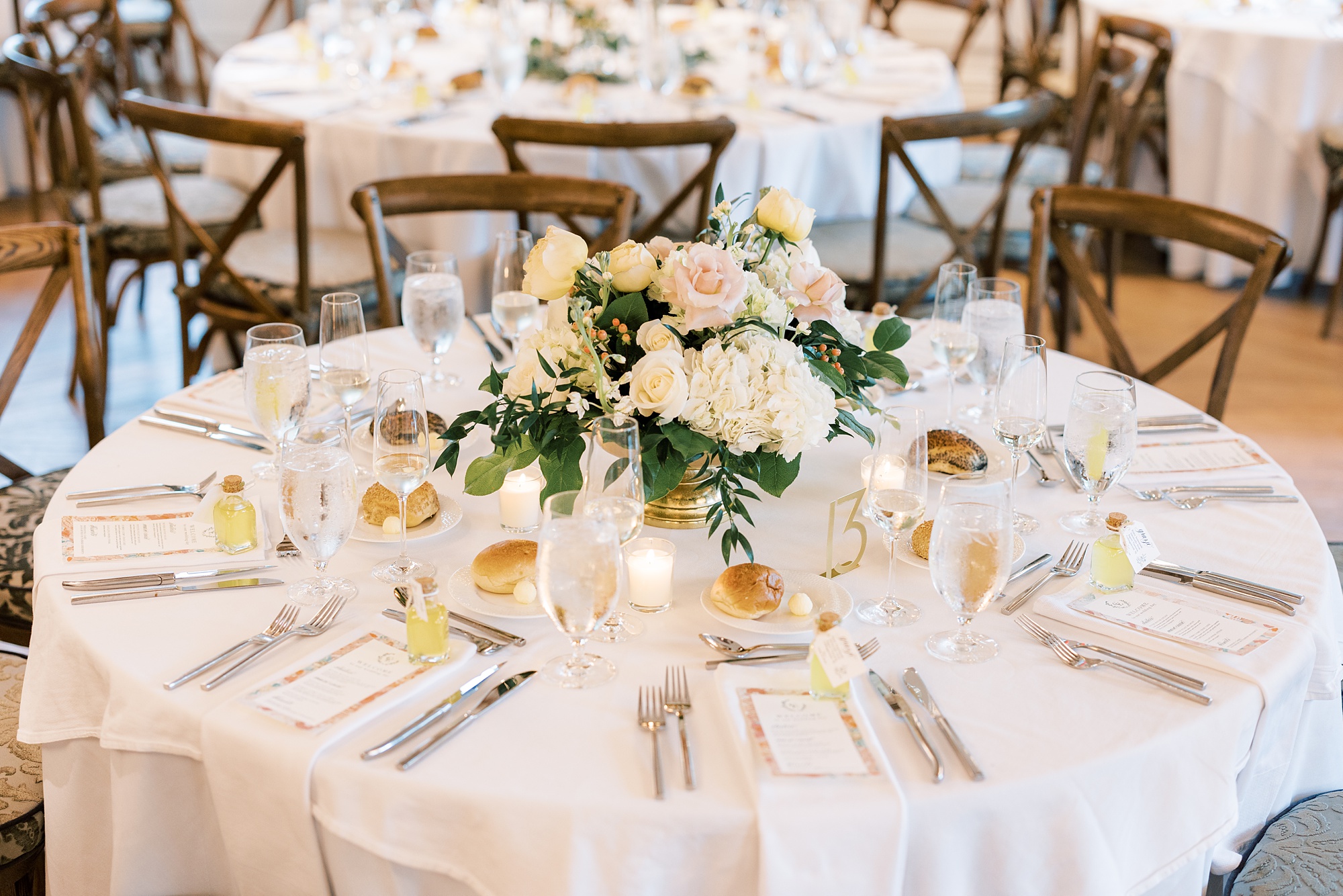 reception table with white and peach flowers 