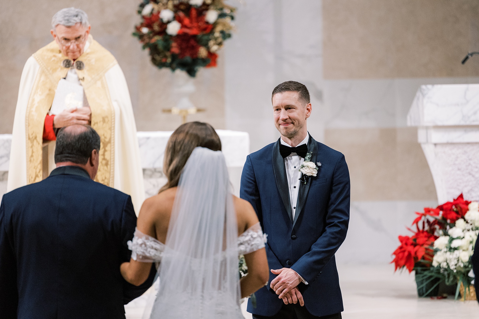 groom in blue suit tears up looking at bride for ceremony 