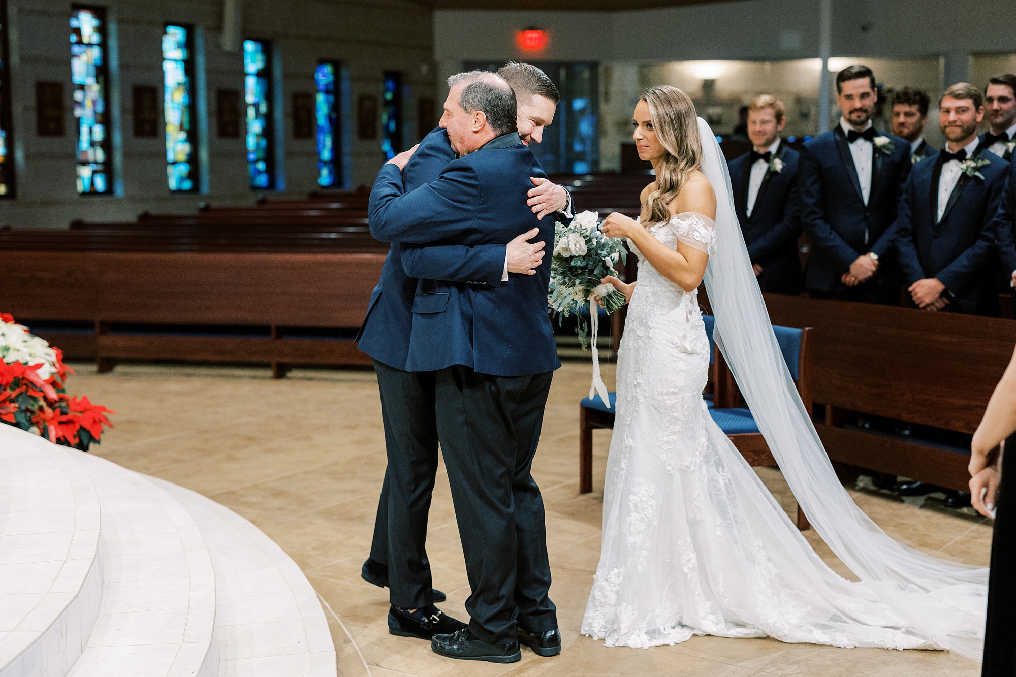 father of bride hugs groom during wedding ceremony at St. Helen's Church in Westfield NJ