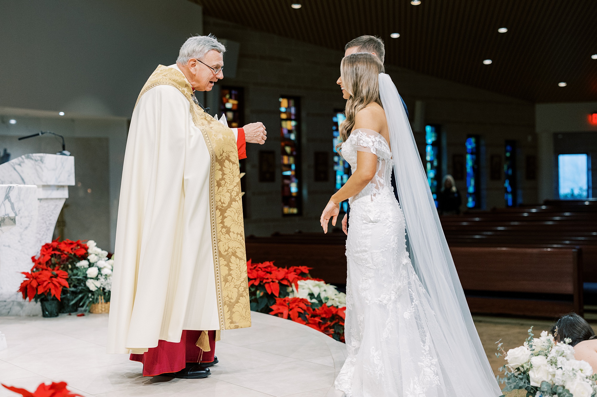 priest nods to bride and groom during wedding ceremony at St. Helen's Church in Westfield NJ