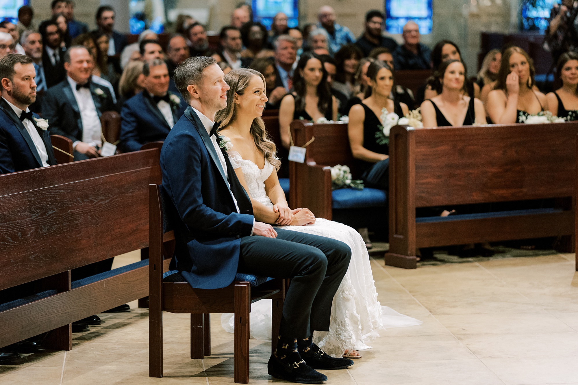 newlyweds sit together during wedding ceremony at St. Helen's Church in Westfield NJ