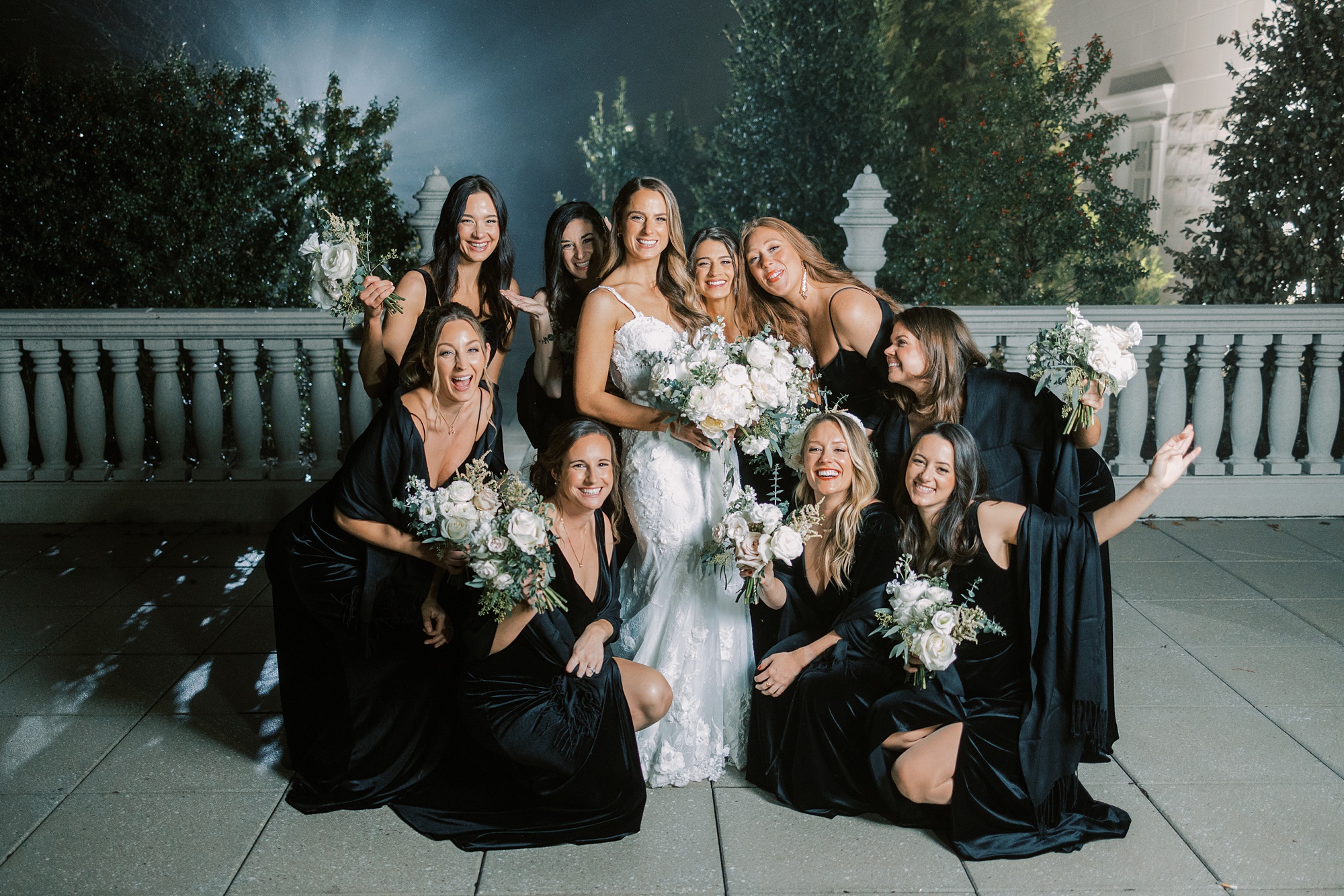 bridesmaids huddle together around bride in fog at New Jersey park
