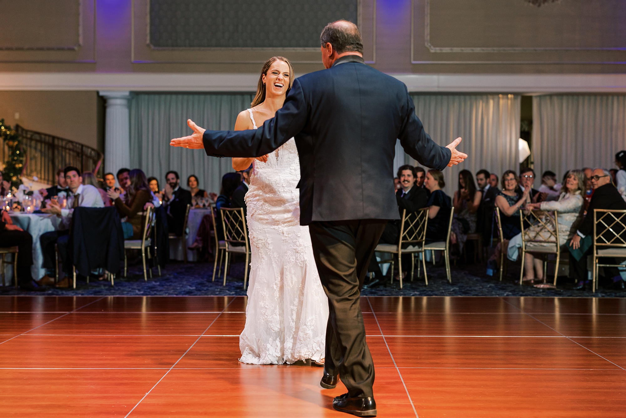 father of bride approaches bride on dance floor 