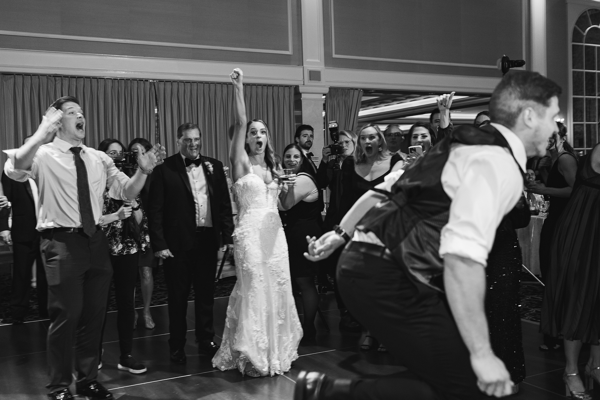 bride and groom cheer during New Jersey wedding reception 