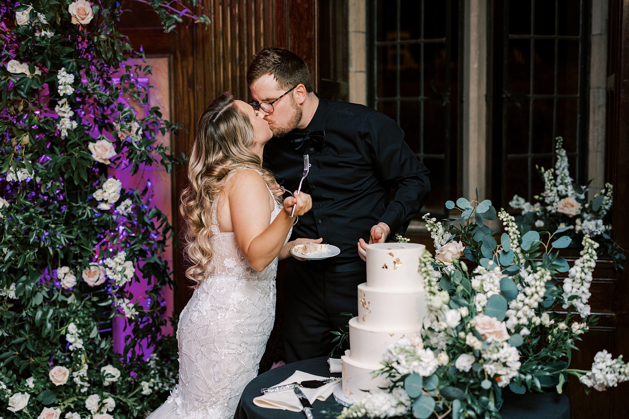 newlyweds kiss after cake cutting 