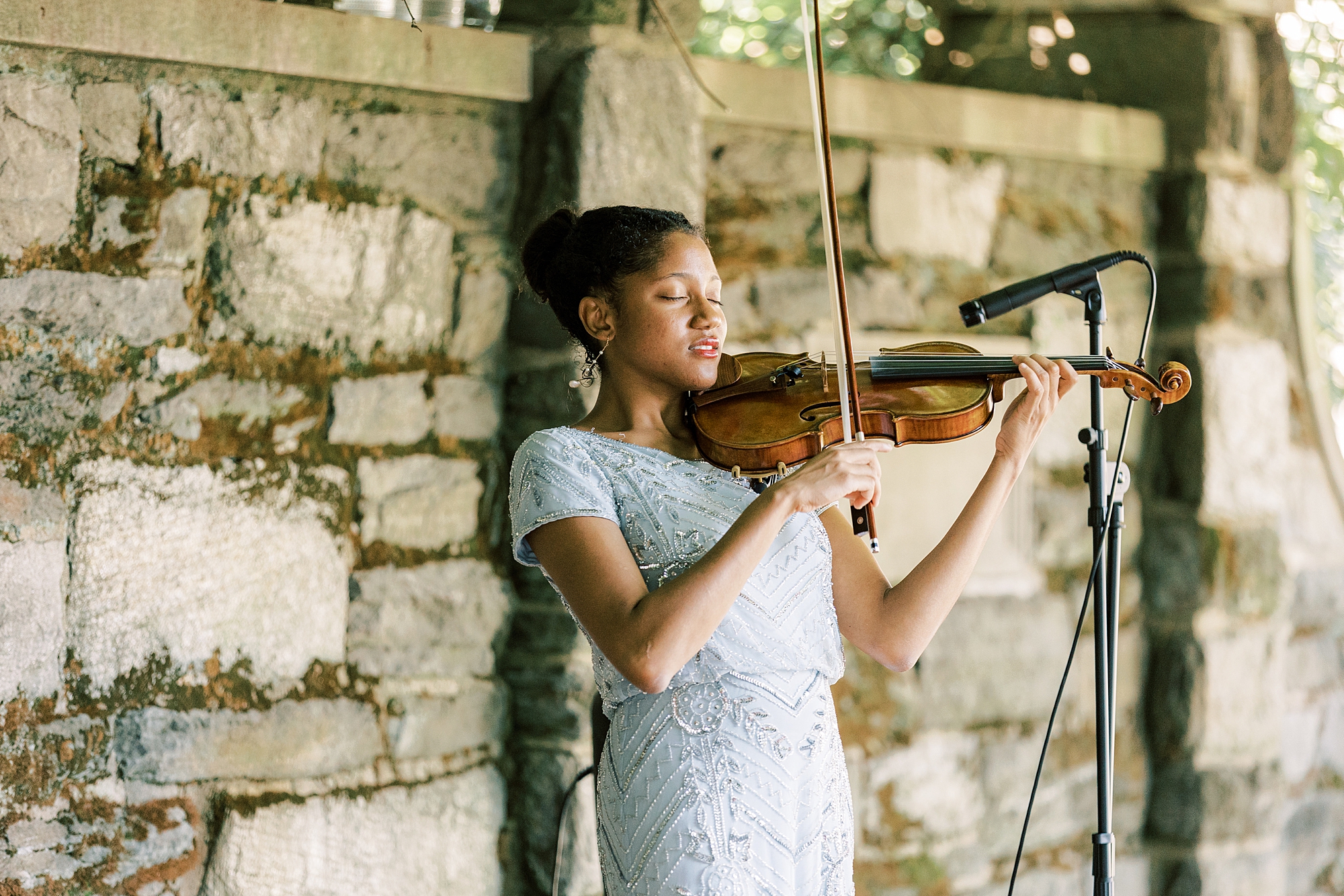 violinist plays during wedding ceremony at Curtis Arboretum