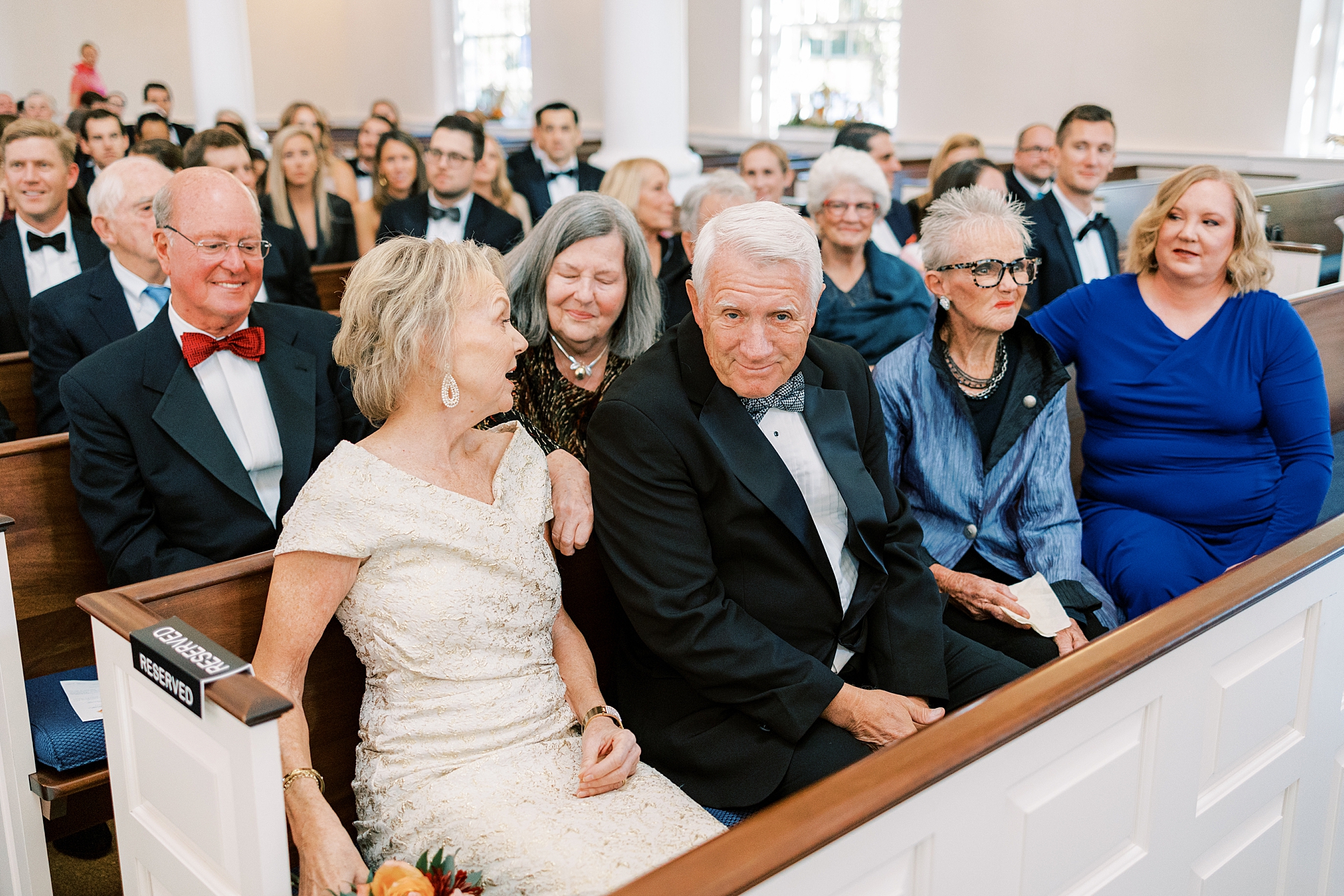 wedding guests sit in pews at St. David’s Episcopal Church 