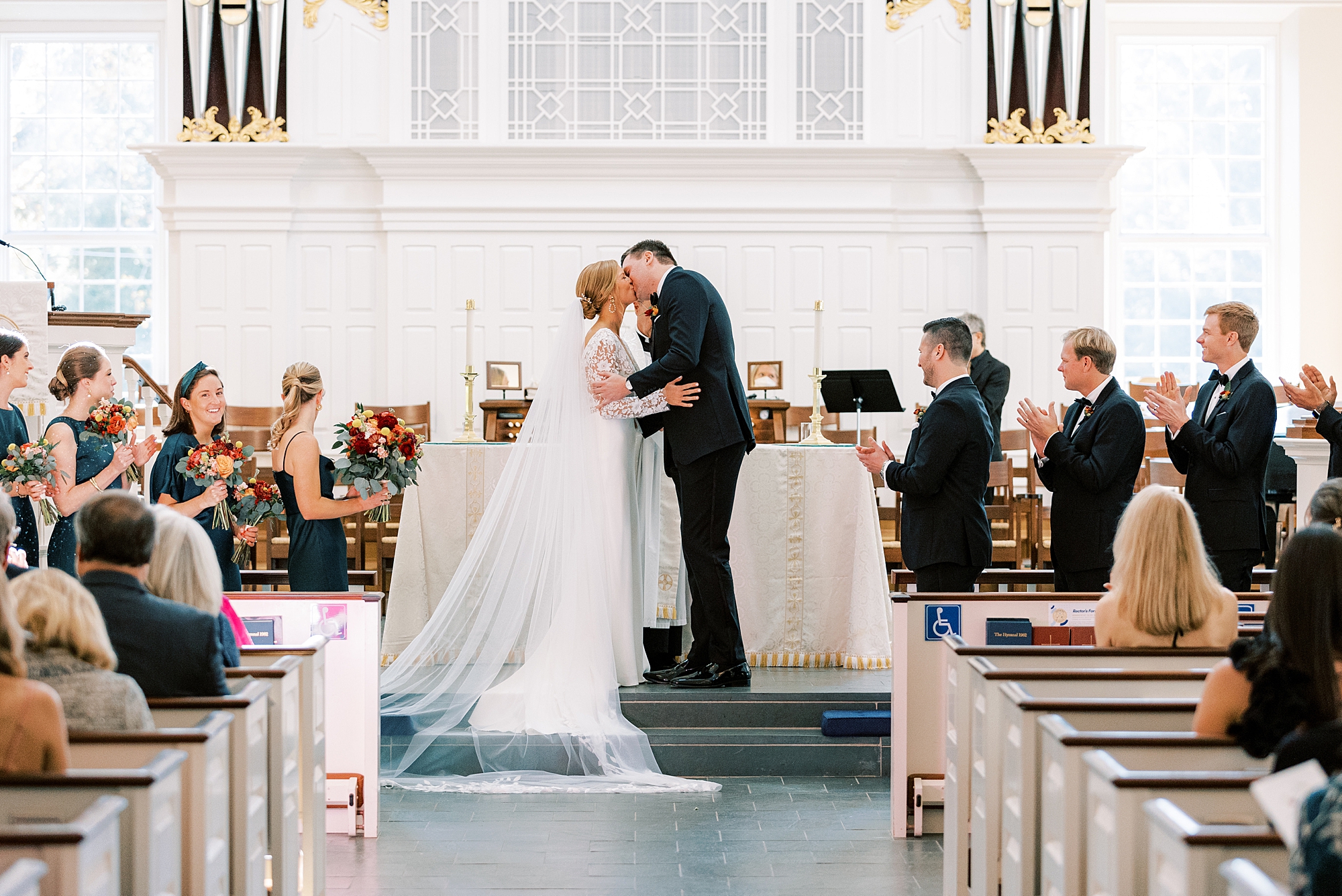 bride and groom kiss during wedding ceremony at St. David’s Episcopal Church 