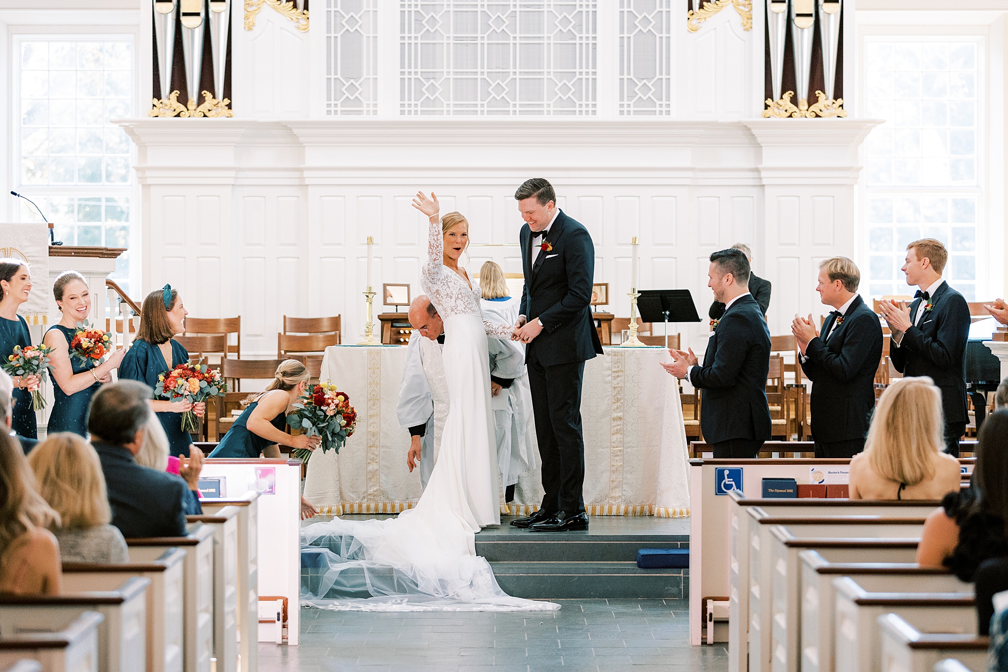 bride waves to guests inside St. David’s Episcopal Church 