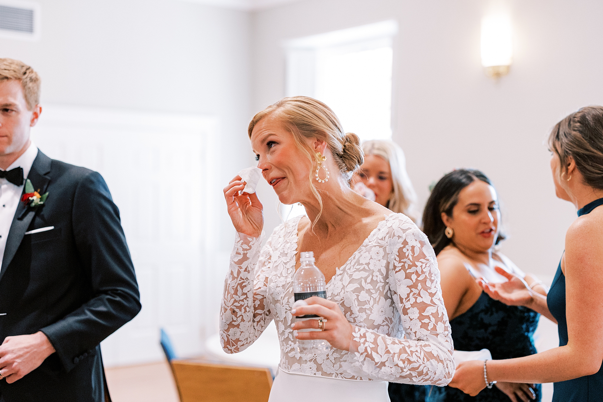bride wipes away tears after wedding ceremony 