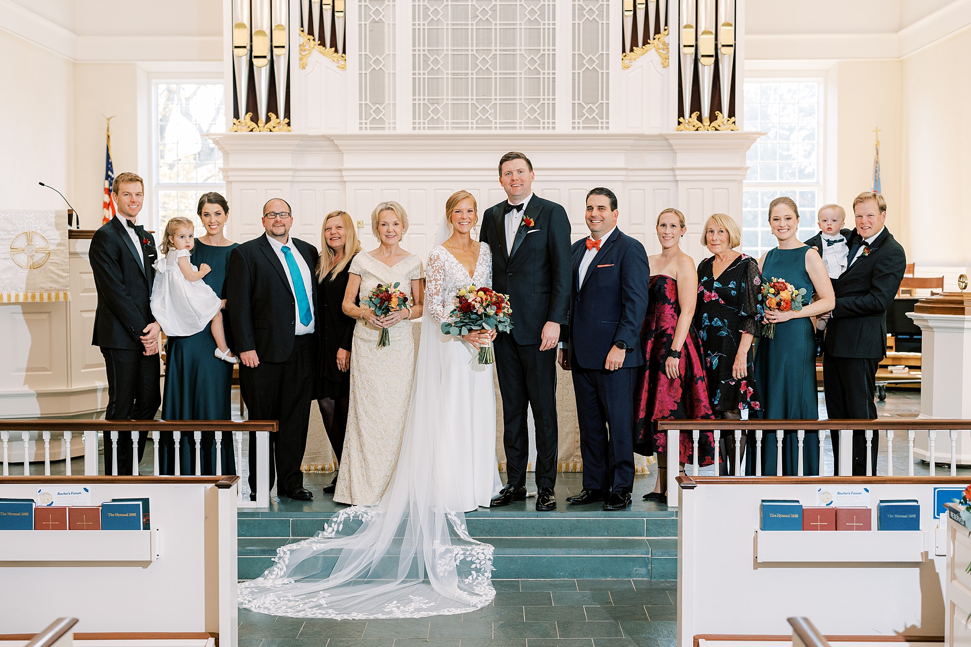bride and groom pose with family inside St. David’s Episcopal Church 