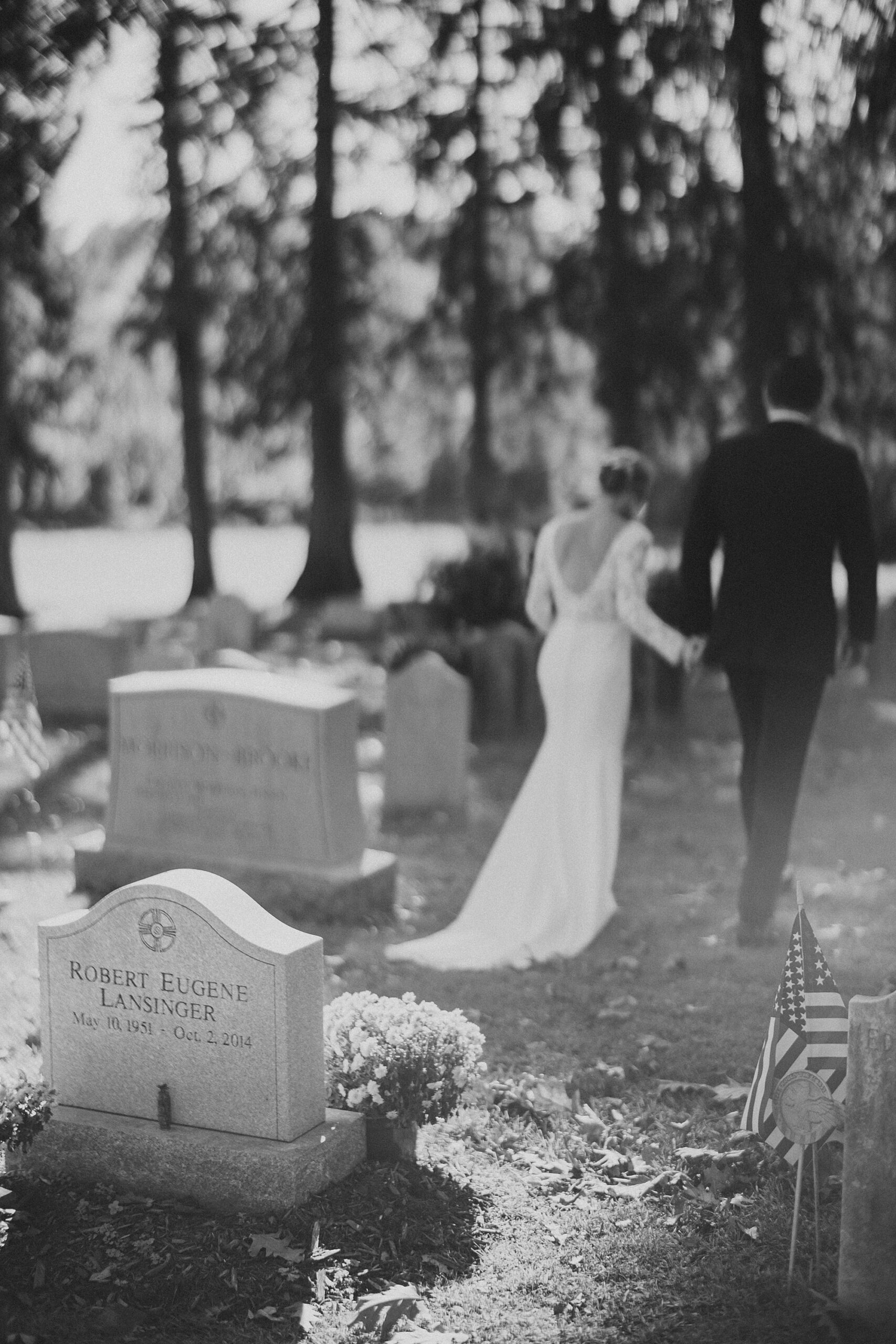 bride and groom hold hands leaving gravesite for her father 